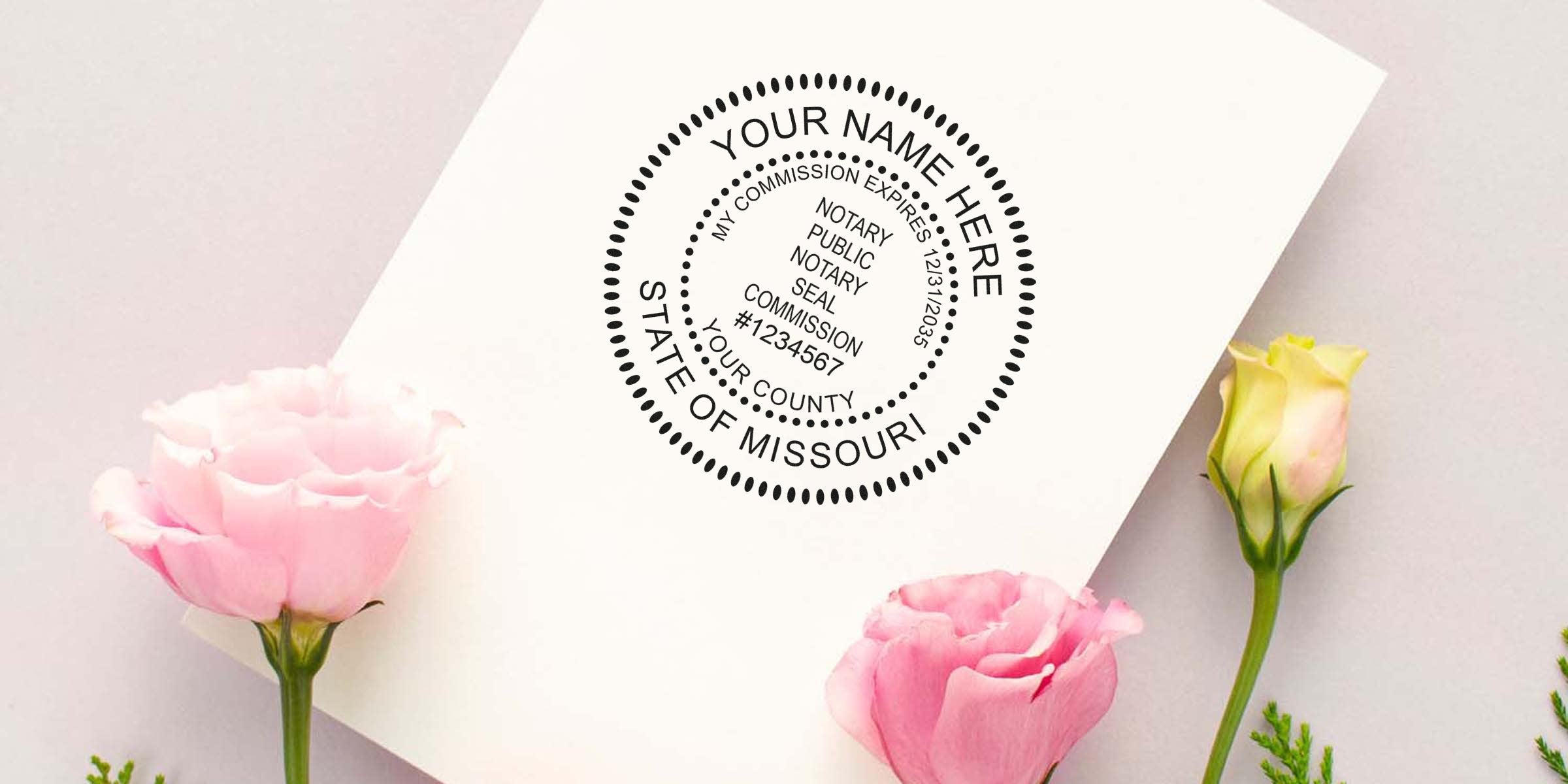 Mockup of a customizable Missouri notary seal stamp printed on a white card, surrounded by pink and cream roses on a pastel background