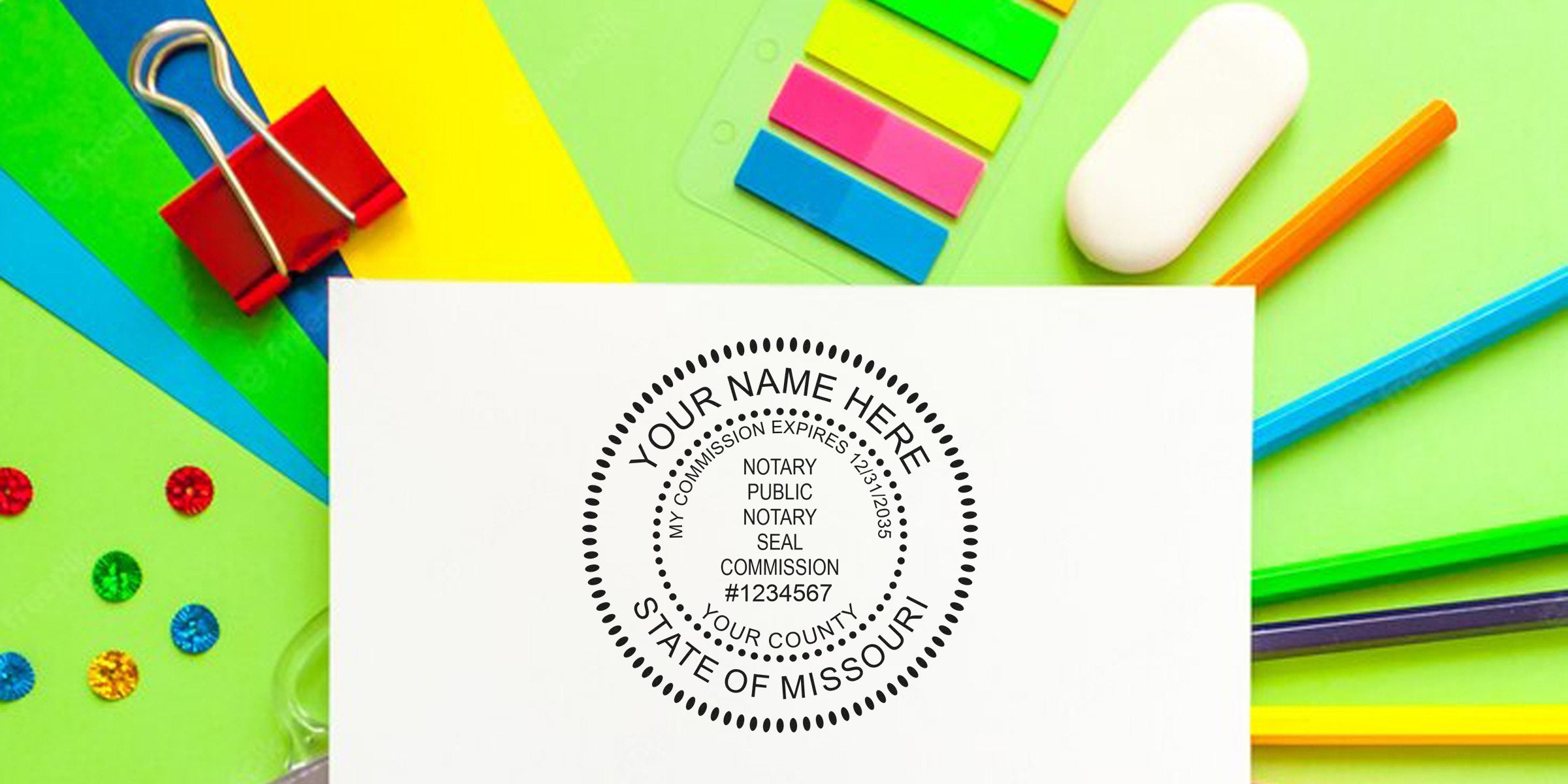 Notary seal mockup on white paper showing "State of Missouri" stamp and commission details, set against colorful office supplies and stationery.