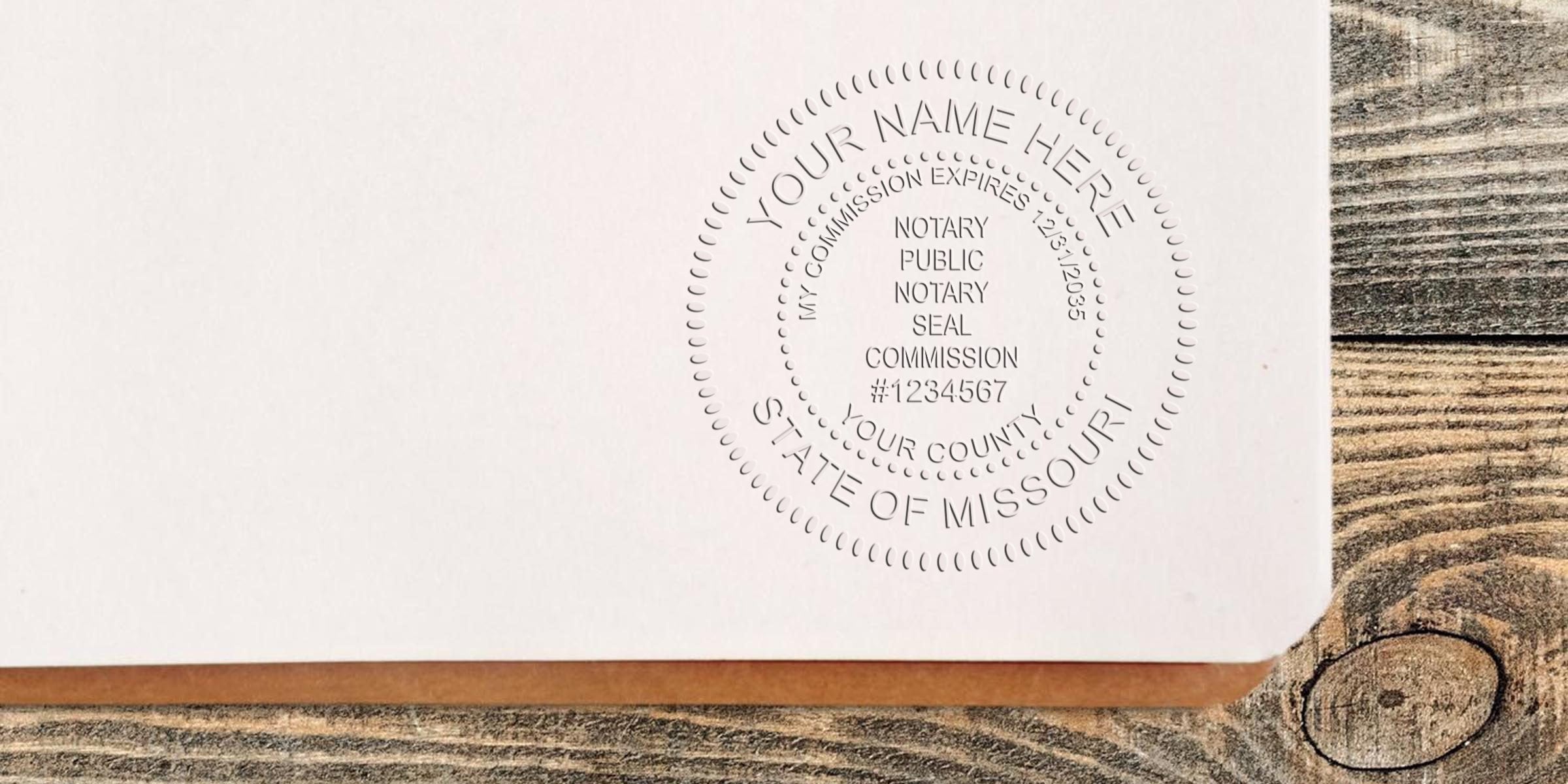 Embossed notary public seal impression on white document corner reading "State of Missouri" with commission details on a wooden table