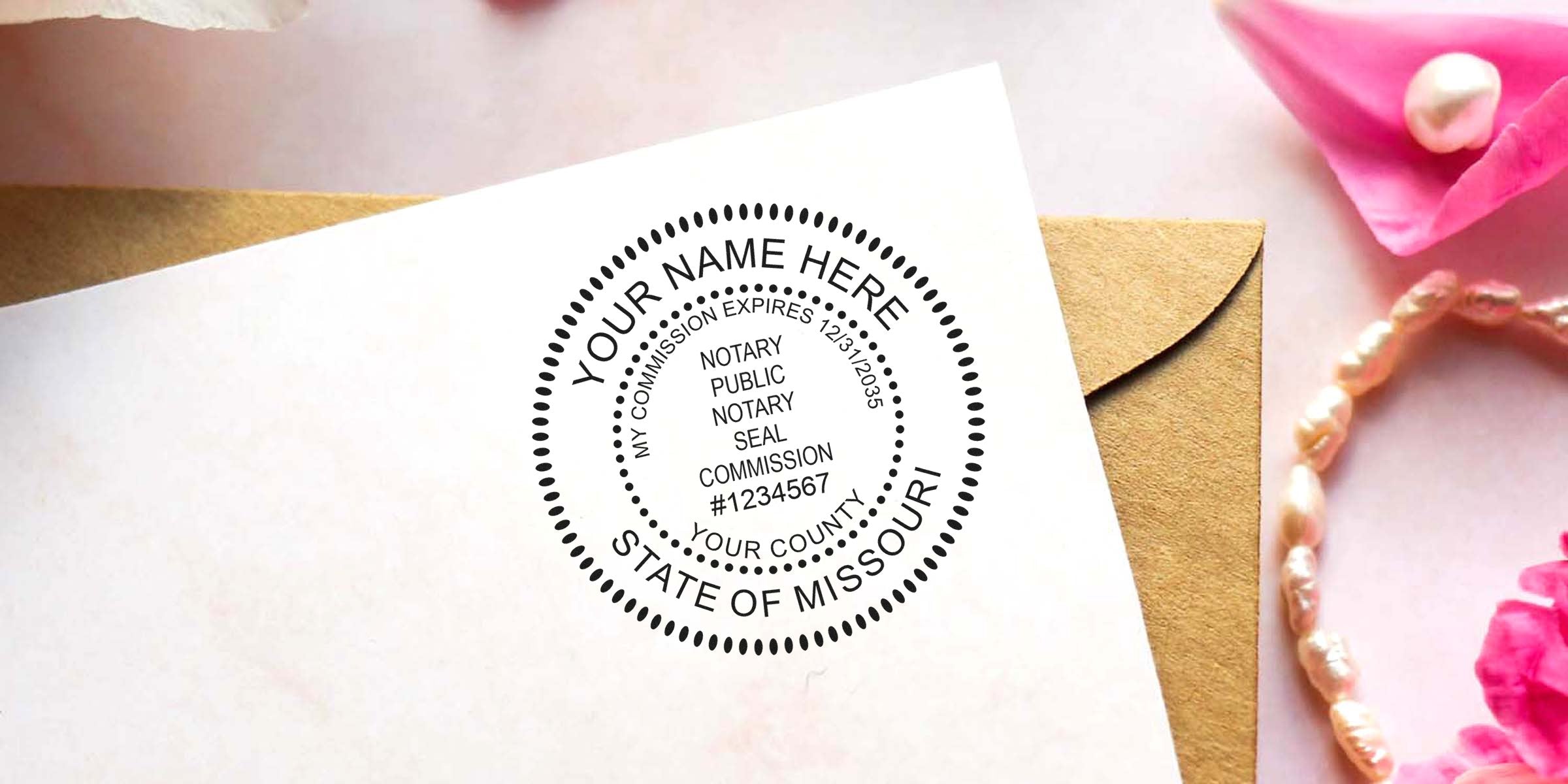Mock notary public round seal stamp on white stationery reading "Your Name Here, State of Missouri" beside a kraft envelope, pink flowers and a pearl bracelet