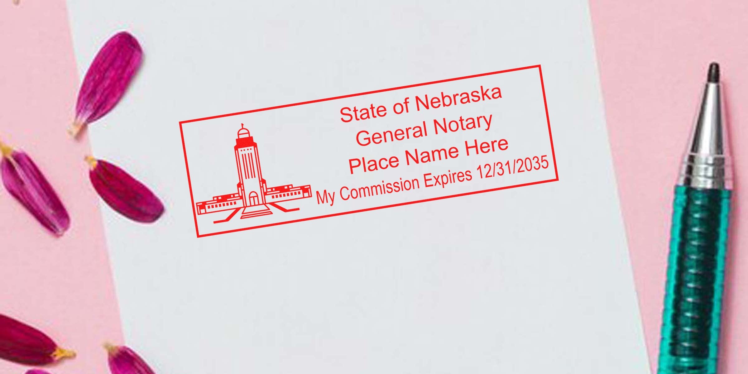 Red State of Nebraska notary stamp imprint on white paper reading "General Notary" with expiration date, teal pen and pink flower petals nearby.