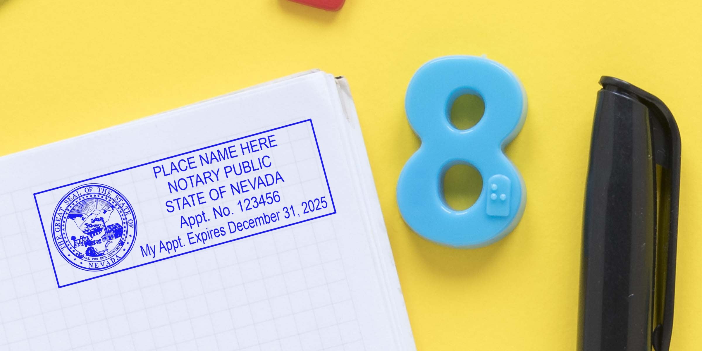 Blue notary public stamp impression for State of Nevada on a white notebook page, next to a blue plastic number 8 and a black pen on a bright yellow background