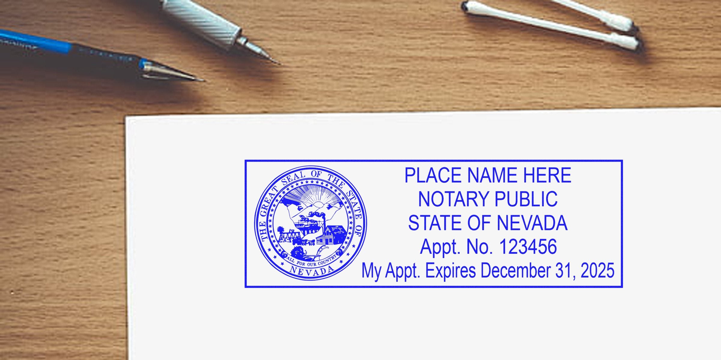 Blue Nevada notary public stamp mockup on white paper showing state seal, appointment number and expiration date, with pens on wooden desk