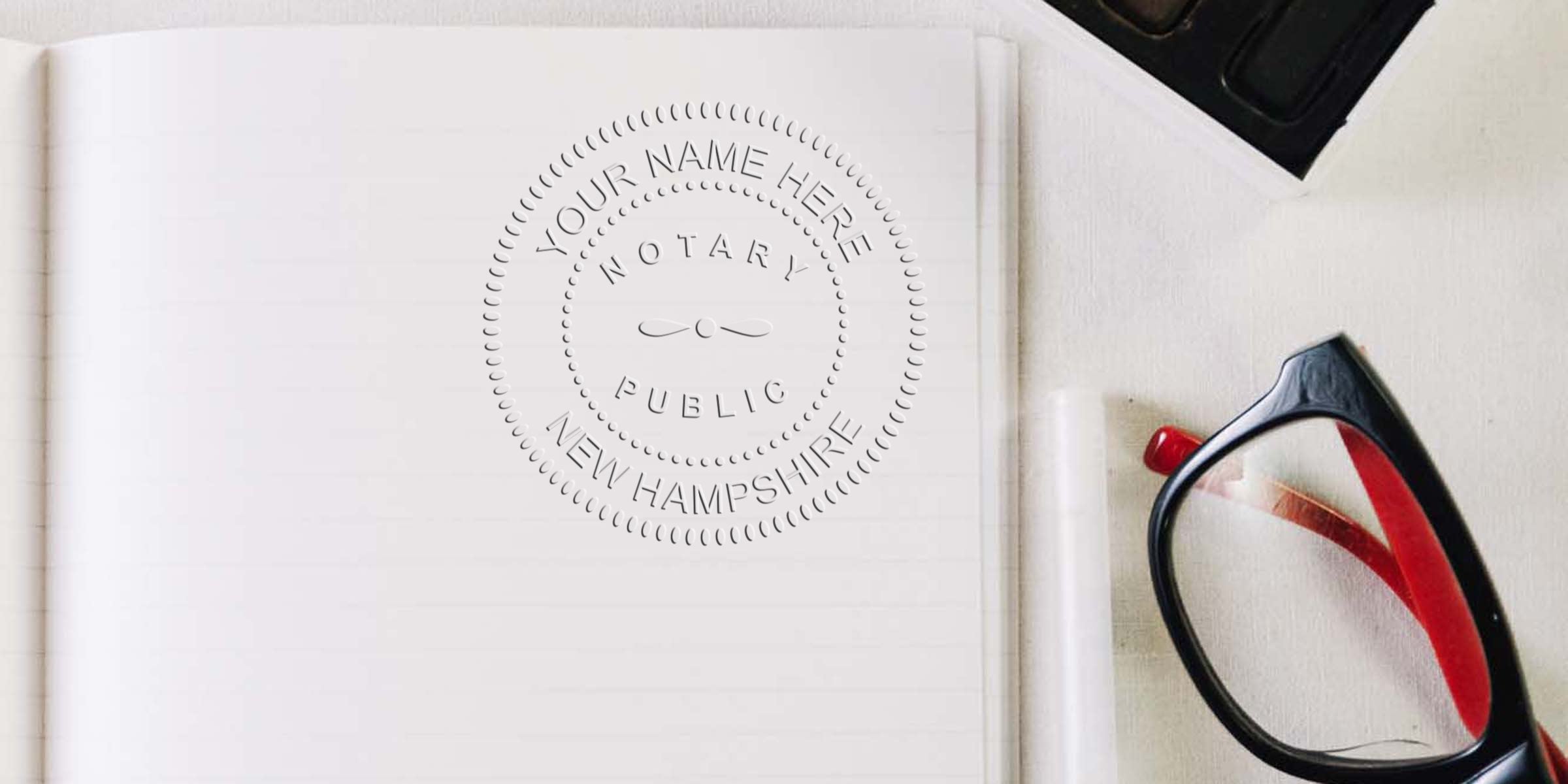 Embossed notary public seal reading "Your Name Here, New Hampshire" on an open lined notebook page with black-and-red eyeglasses and pen nearby, flatlay legal stationery for notary, signing, and document preparation.