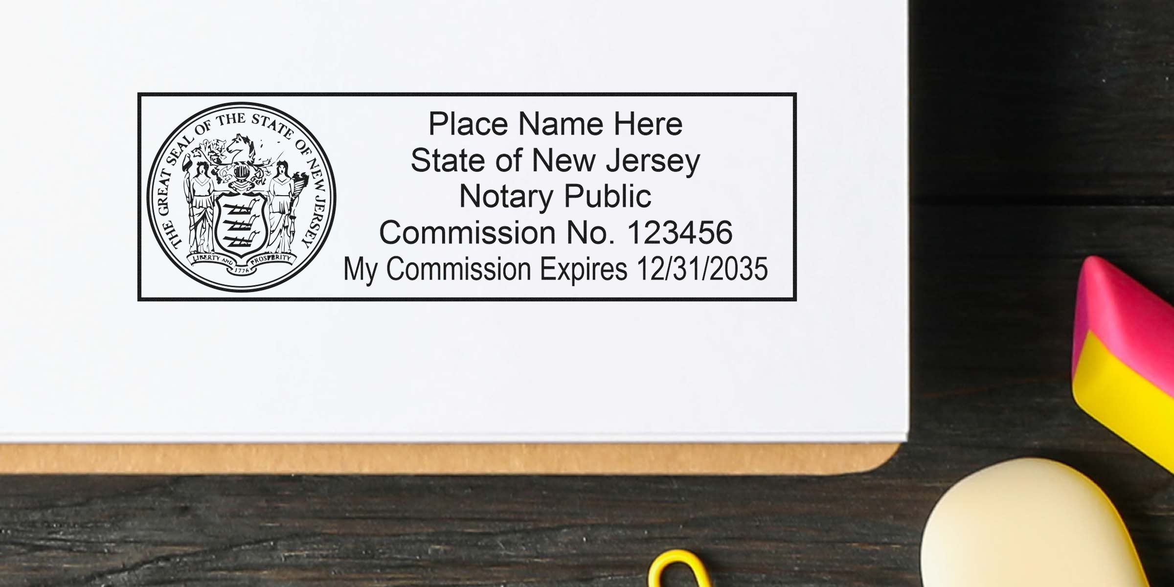 Close-up of a New Jersey notary public stamp on paper displaying the state seal, placeholder name, commission no. 123456 and commission expiration 12/31/2035, shown on a dark wood desk with mouse and colorful eraser.