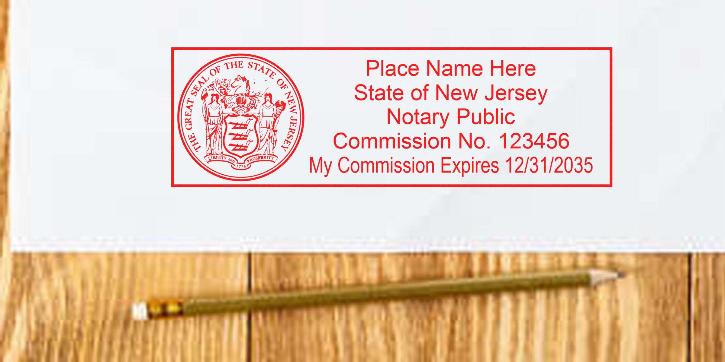 Red rectangular New Jersey notary public stamp sample with state seal, placeholder name, commission no. 123456 and expiration 12/31/2035 on white paper above a pencil on wood surface