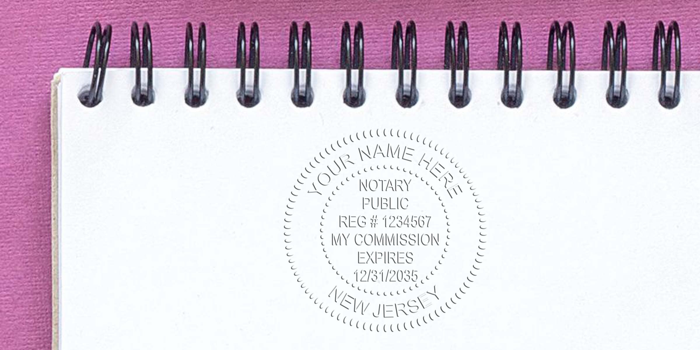 Spiral-bound white notebook on pink background with embossed circular notary public seal reading "Your Name Here, New Jersey" and commission details.