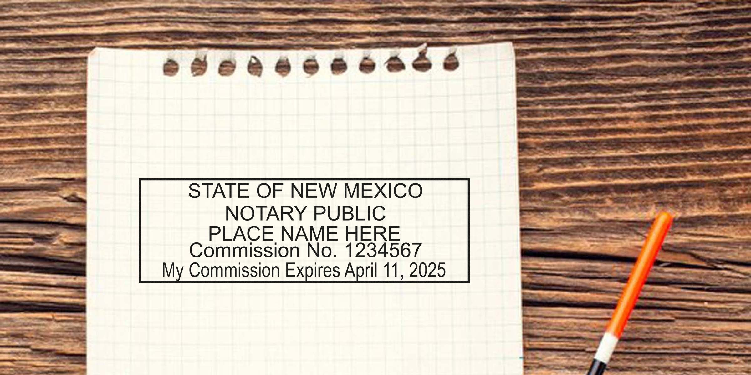 Sample State of New Mexico notary public stamp imprint on graph paper with commission number placeholder and orange pen on wooden table