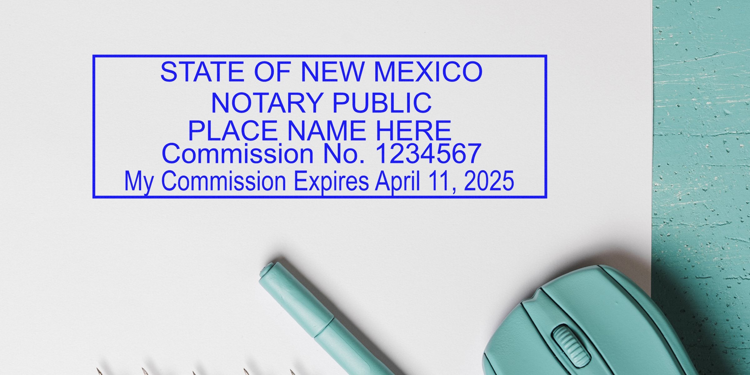 Close-up of State of New Mexico notary public stamp on paper reading "Place Name Here," Commission No. 1234567, commission expires April 11, 2025, accompanied by a teal pen and wireless mouse — notary document/office concept