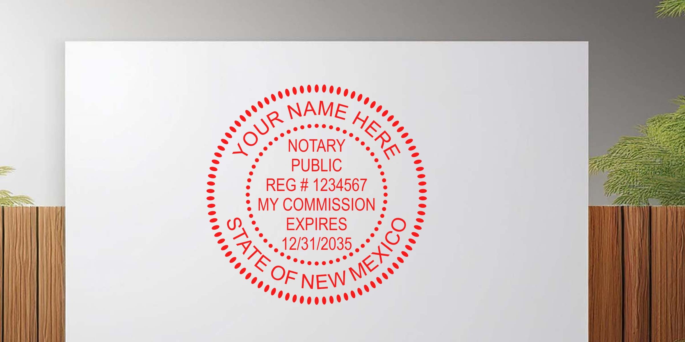 Red circular notary public stamp mockup reading "Your Name Here, Notary Public, Reg #1234567, My Commission Expires 12/31/2035, State of New Mexico" on white background with wooden panel and green plant accents