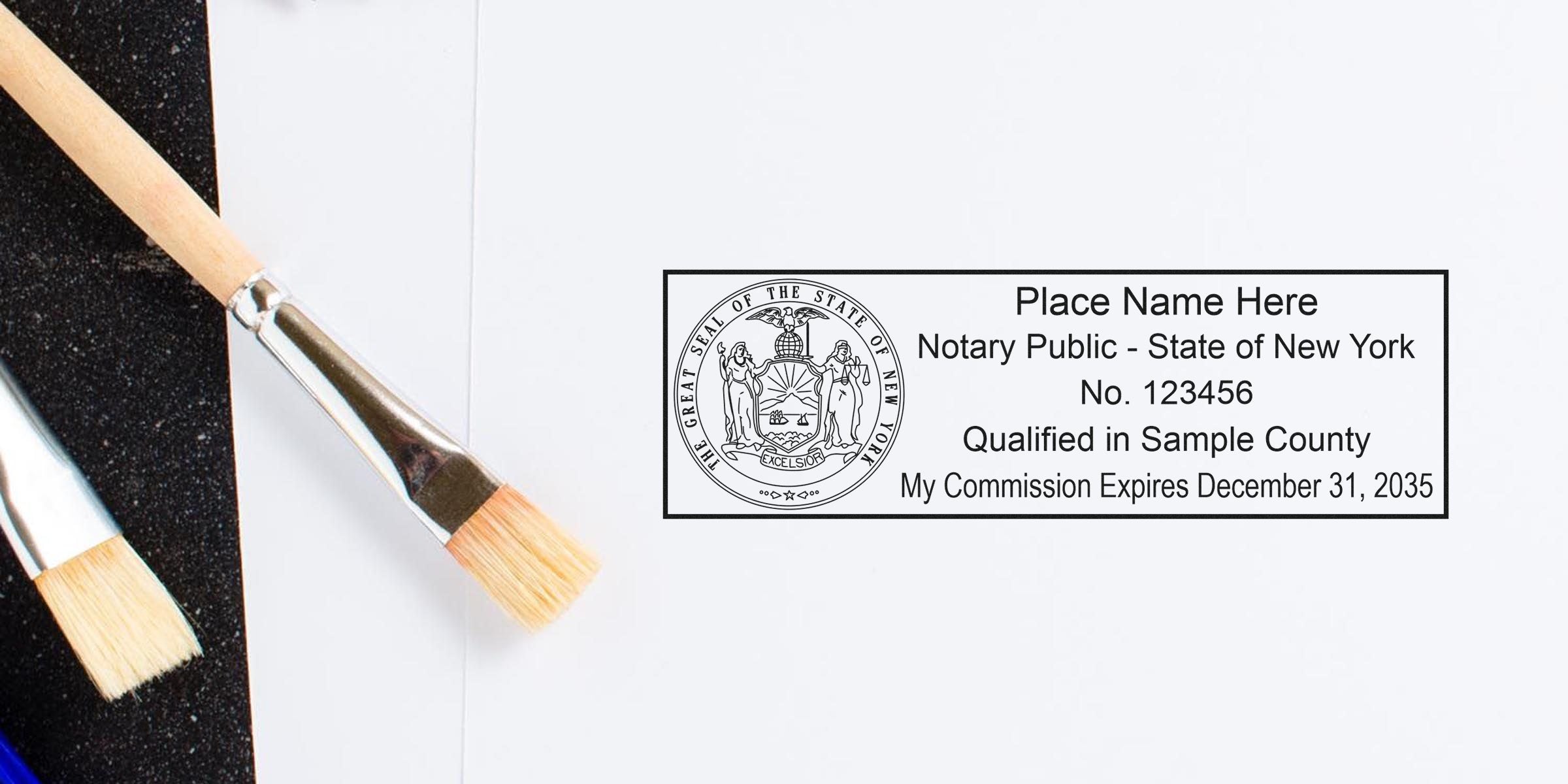 Notary public rubber stamp impression for State of New York showing sample name, commission number and expiration details placed on white paper next to two paintbrushes