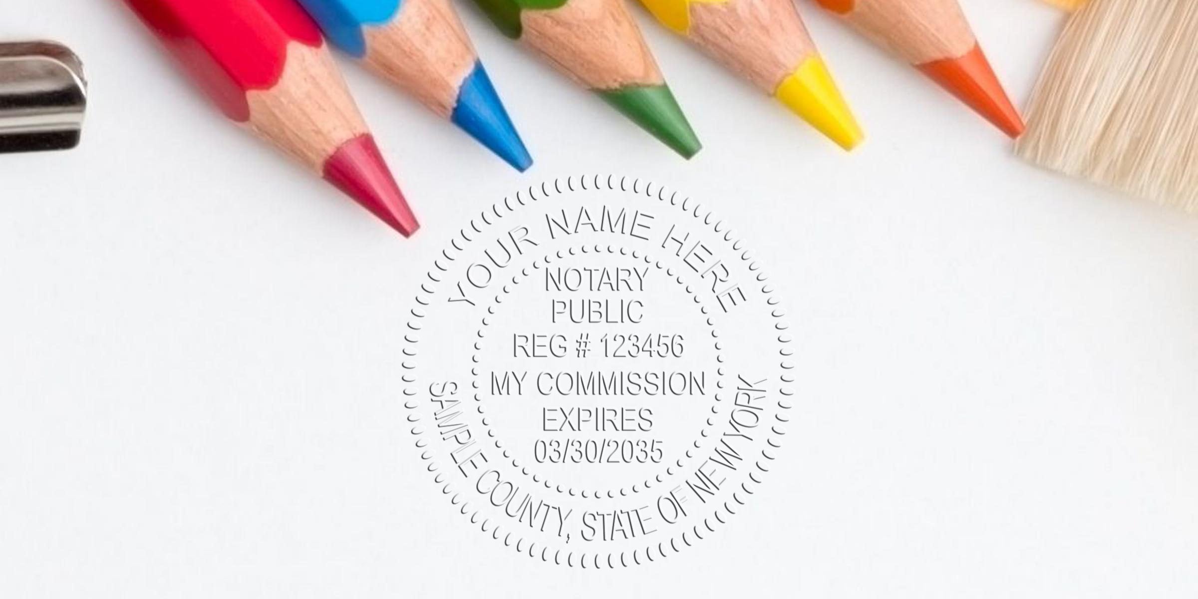 Close-up of sharpened colored pencils and paintbrush beside an embossed notary public seal on white paper — creative stationery and legal services concept for art, education, office supplies, or notary-related content.
