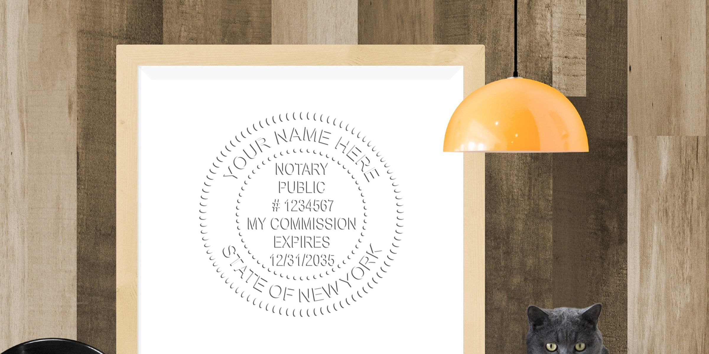 Framed mockup of a notary public seal print in a light wood frame on a rustic wood-paneled wall, with an orange pendant lamp and a gray cat peeking at bottom right