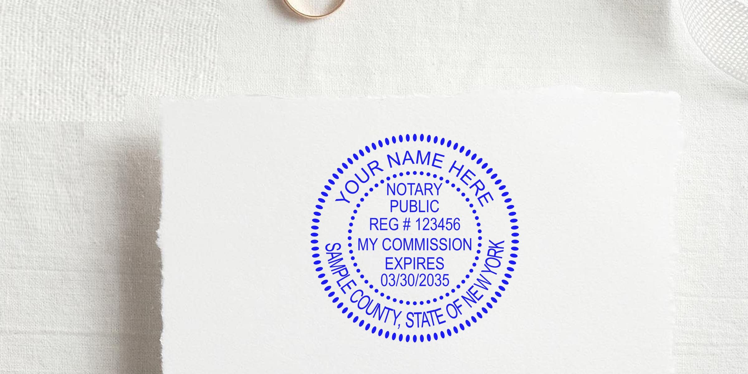 Blue circular notary public seal stamped on white textured paper reading "Your Name Here, Notary Public, Reg #123456, My Commission Expires 03/30/2035, Sample County, State of New York."