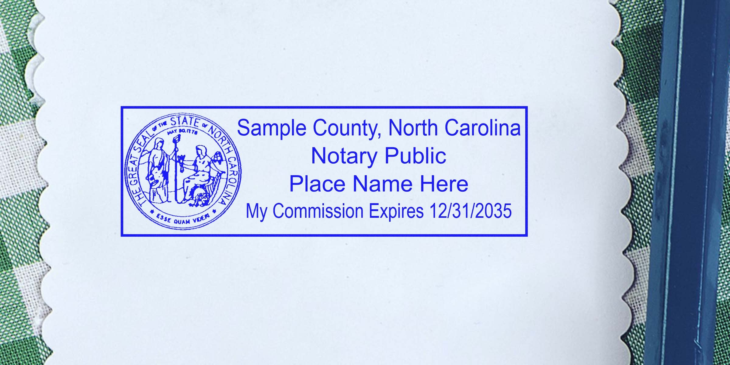 Blue North Carolina notary public stamp on scalloped white paper reading "Sample County, North Carolina Notary Public Place Name Here My Commission Expires 12/31/2035" with circular state seal at left.