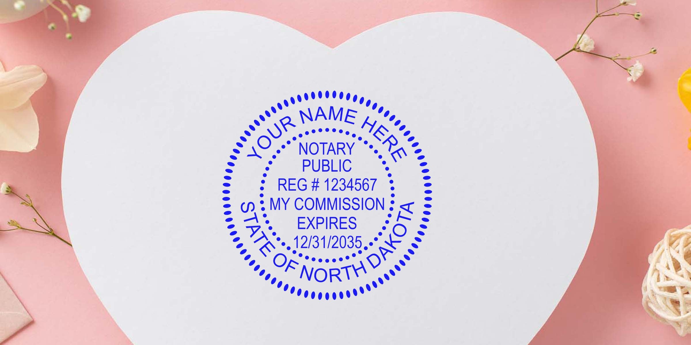 Heart-shaped white card on pink background with flowers and a blue circular notary public stamp reading "Your Name Here," State of North Dakota, registration number and commission expiry date.
