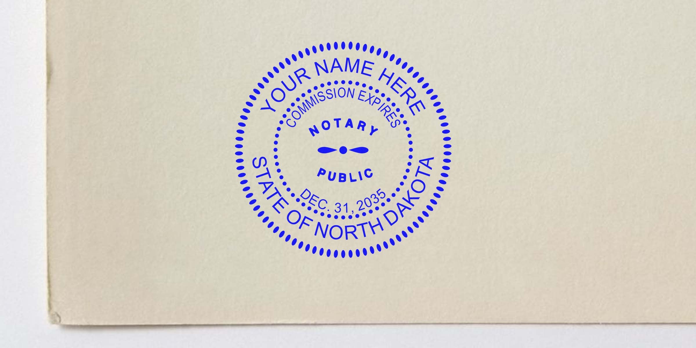 Blue circular North Dakota notary public stamp on beige paper reading "Your Name Here," "Notary Public," "State of North Dakota" and expiration date Dec. 31, 2035.