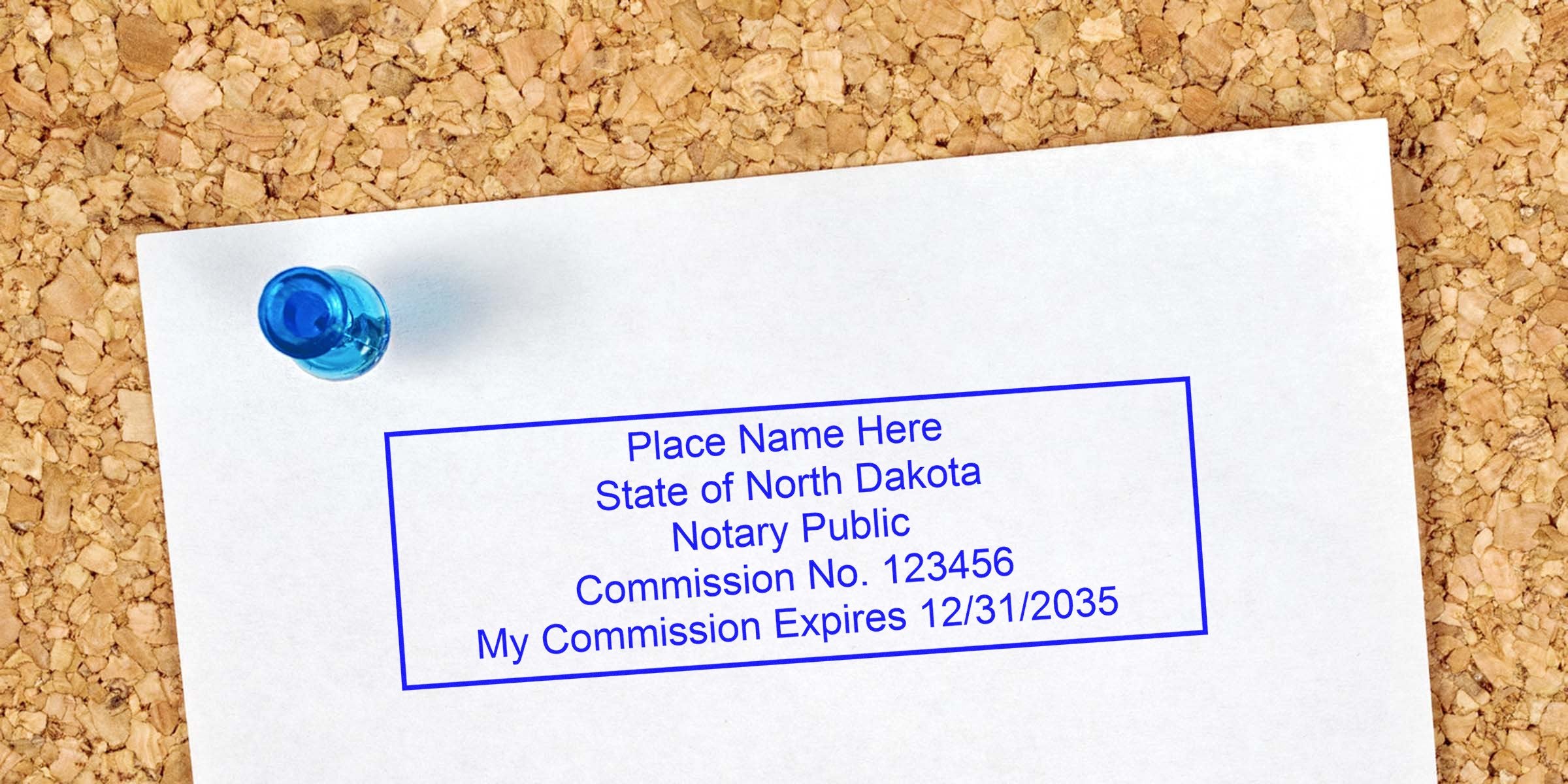 White paper pinned to corkboard with blue pushpin showing a blue rectangular State of North Dakota notary public stamp template, sample commission number and expiration date, office document mockup for notary services.