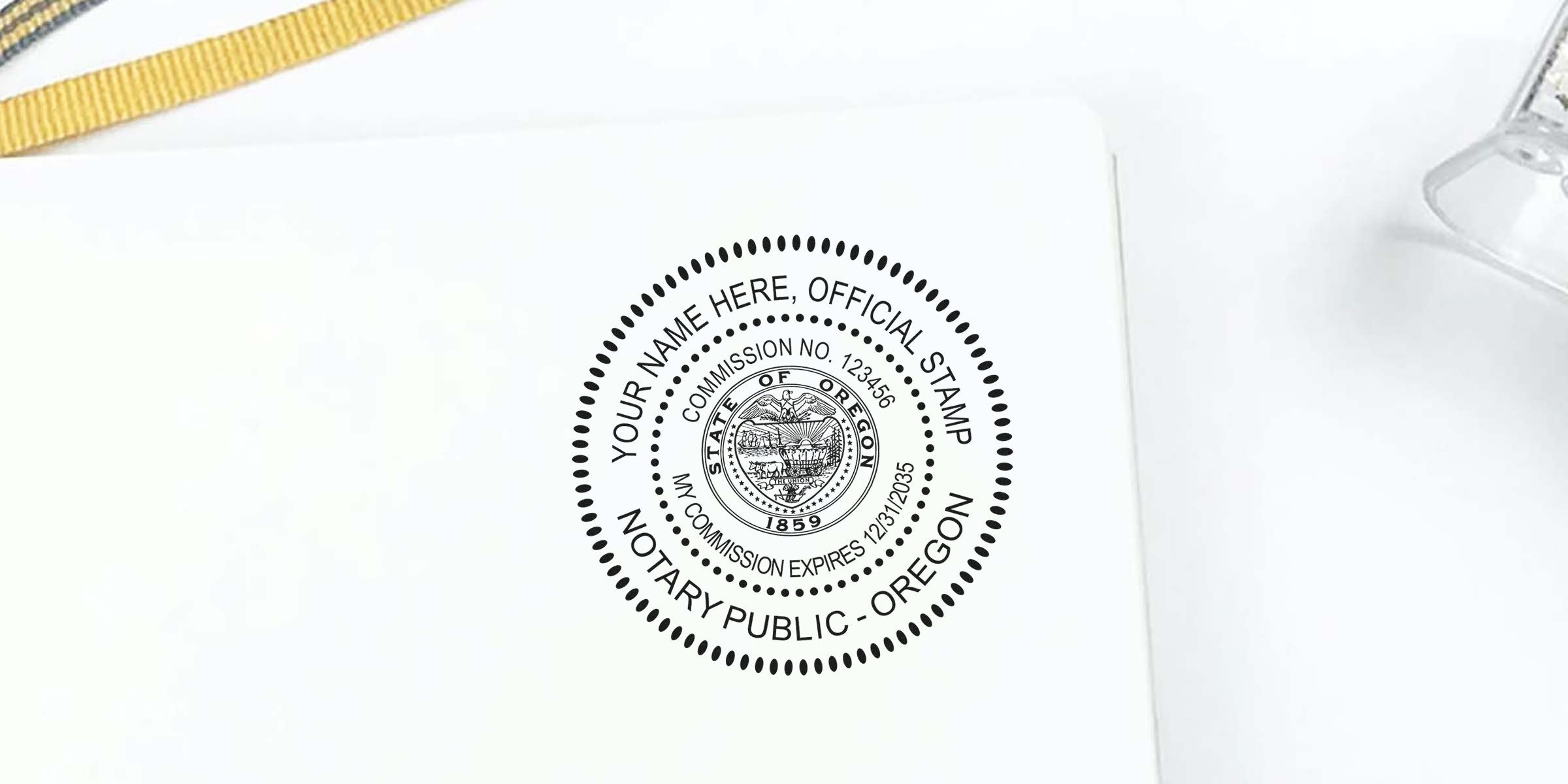 Black circular Oregon notary public seal stamp mockup on white paper, dotted concentric borders, state seal in center, placeholder "Your Name Here", commission number and expiration date — Oregon notary stamp mockup for notary supplies and documentation