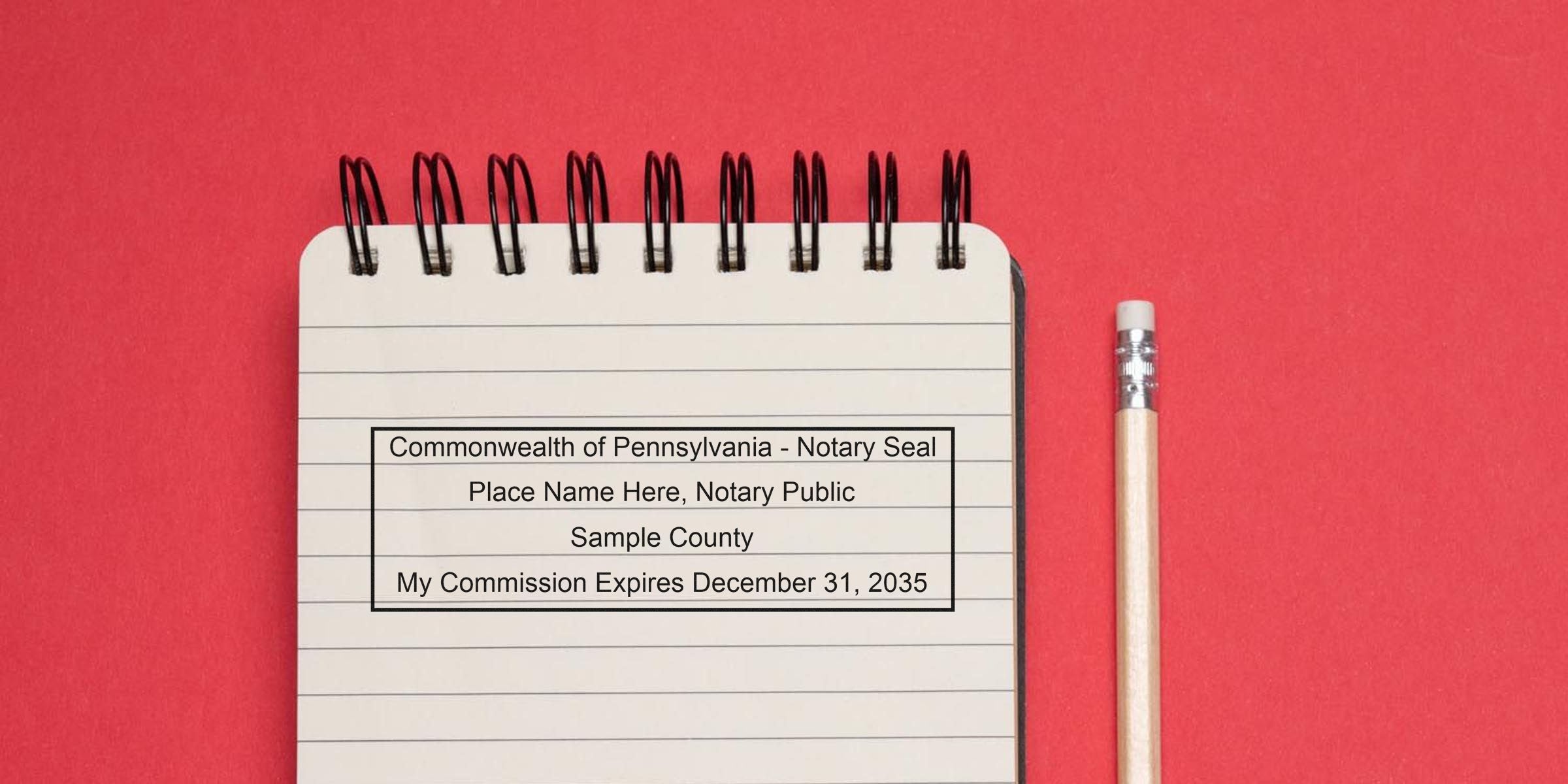 Top-view spiral notebook page showing a rectangular "Commonwealth of Pennsylvania - Notary Seal" template with sample county and commission expiration text, beside a wooden pencil on a red background — notary seal template mockup.