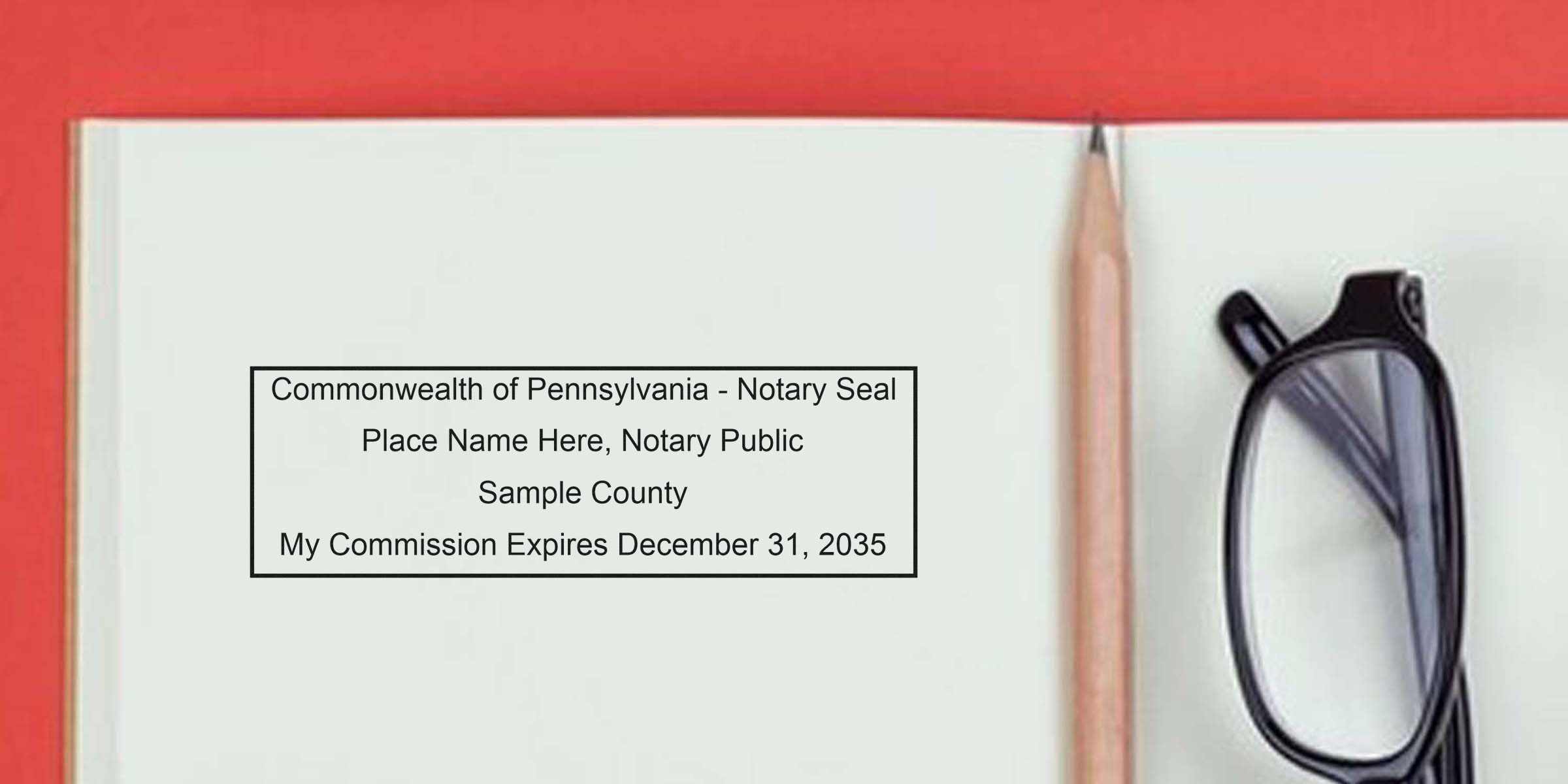 Open notebook showing printed "Commonwealth of Pennsylvania - Notary Seal" sample text, wooden pencil and black eyeglasses on red background — mock notary seal template and office stationery.