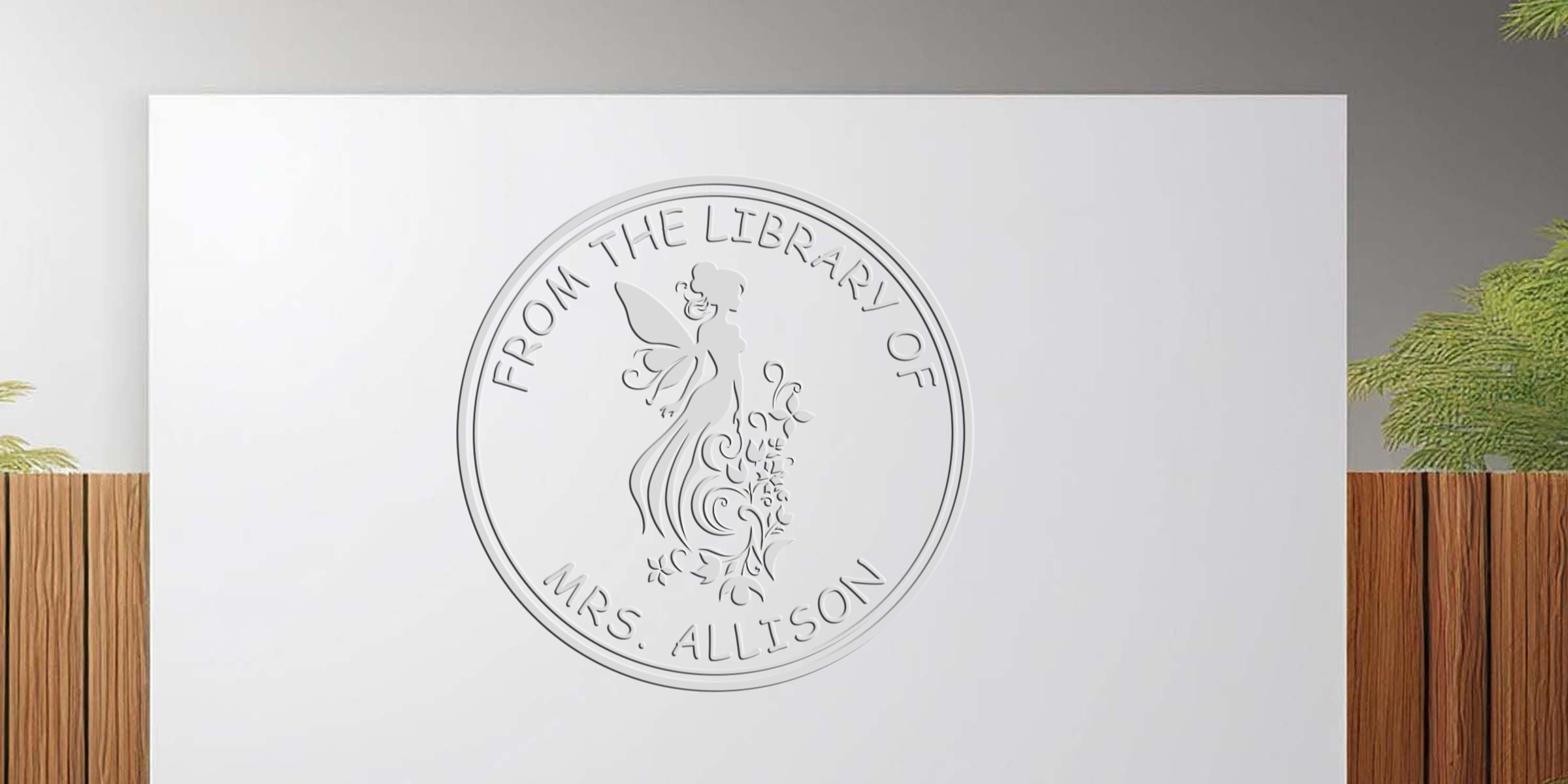 Medallion-style coin with the inscription “From the Library of Mrs. Allison” and a winged angel design.