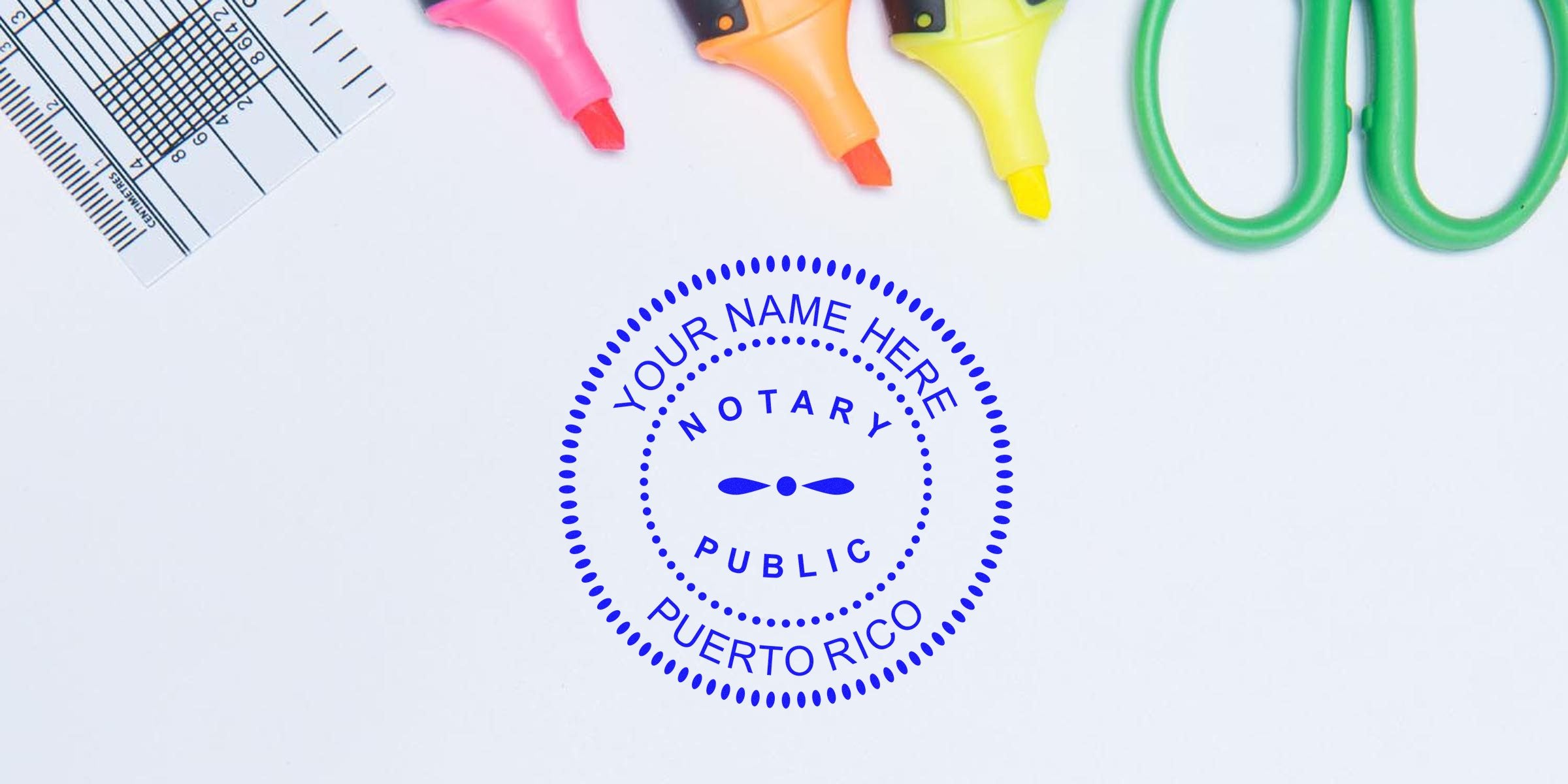 Blue circular notary public seal mockup reading "Your Name Here Puerto Rico" on white desk with colorful highlighters, green scissors and a ruler