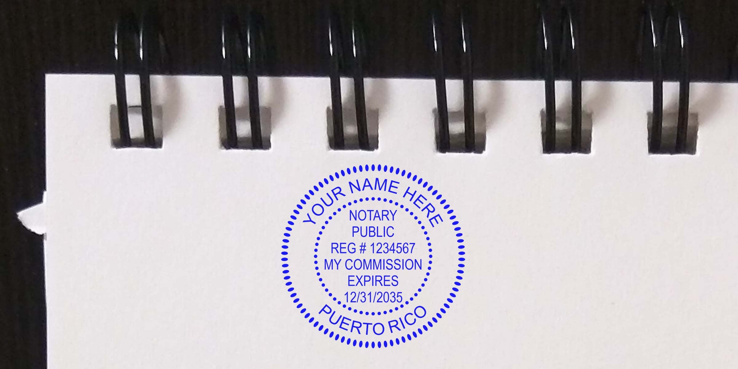 Blue circular Puerto Rico notary public stamp on a white spiral-bound notebook page reading "Your Name Here, Notary Public, Reg #1234567, My Commission Expires 12/31/2035".
