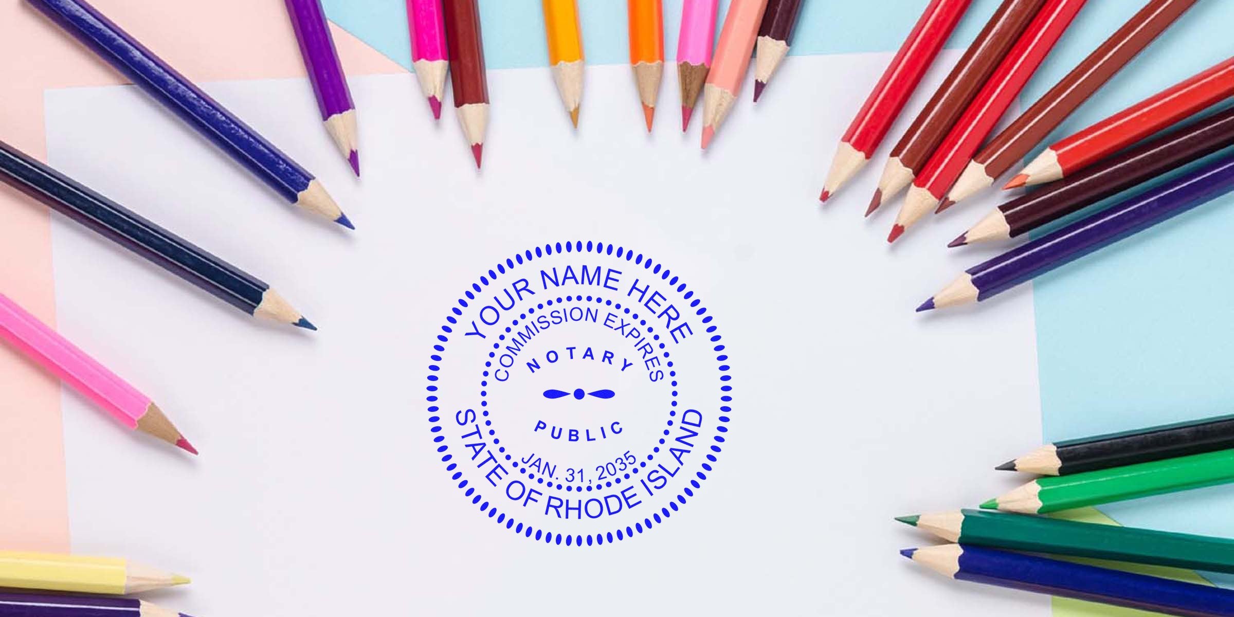 Top-down view of colorful pencils fanned around blank white paper with a blue notary public seal stamp reading "State of Rhode Island."