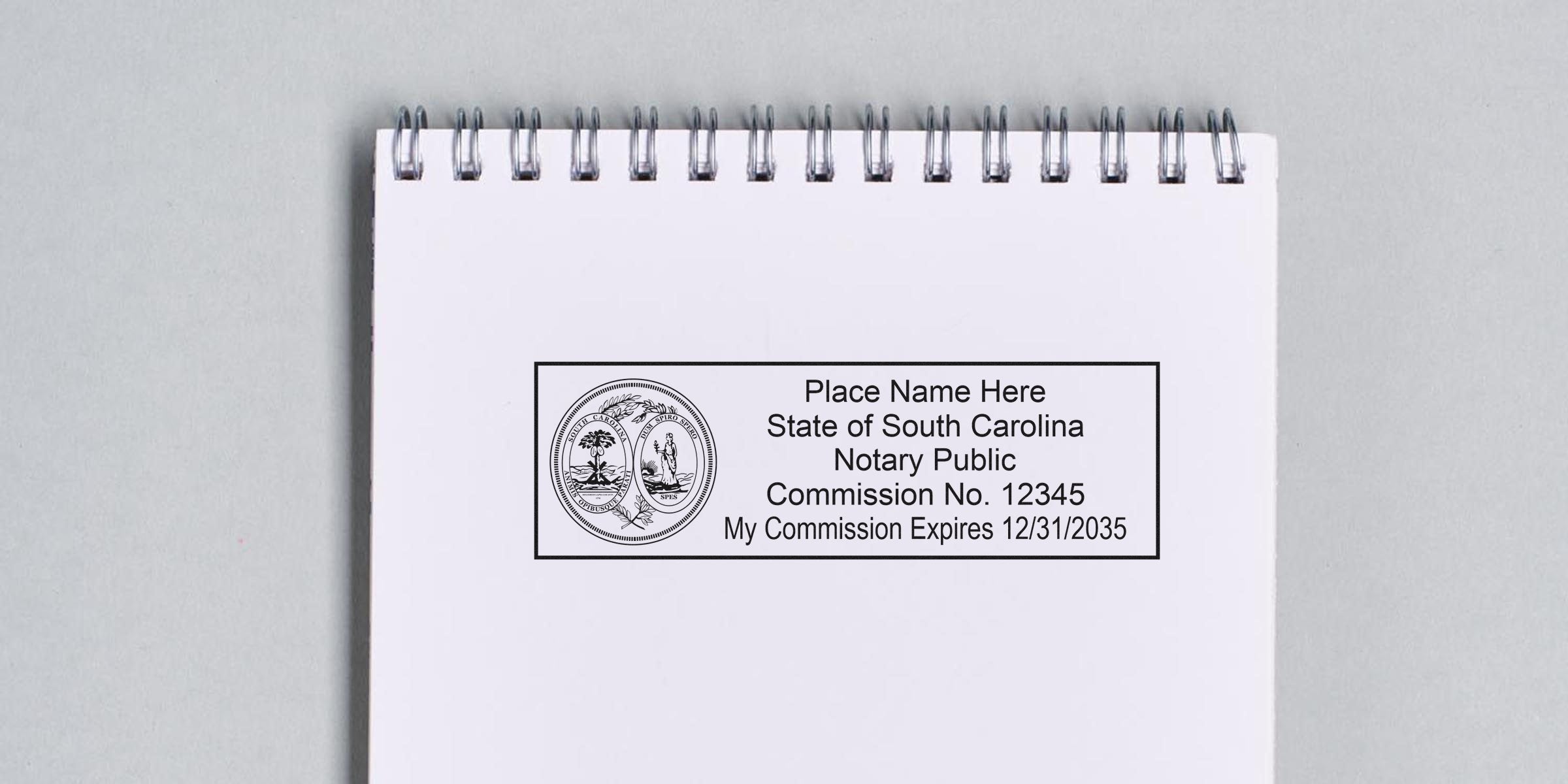 Spiral-bound notebook page with a rectangular South Carolina notary stamp mockup showing state seal, placeholder name, commission number and expiration date.