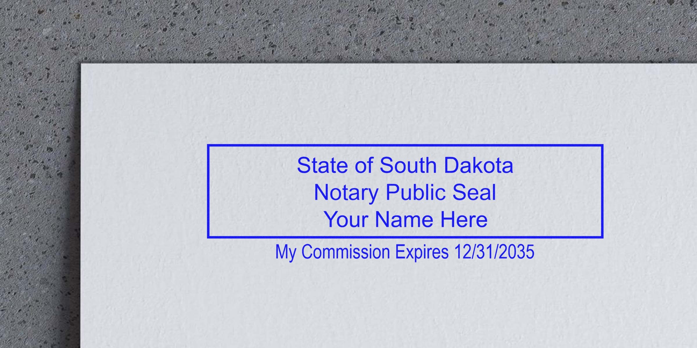 Blue rectangular South Dakota notary public seal stamp on paper reading "State of South Dakota Notary Public Seal, Your Name Here" with commission expires 12/31/2035