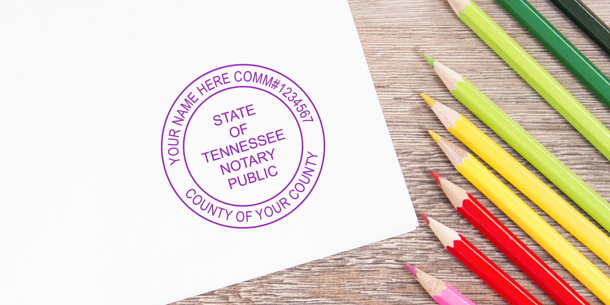 Purple Tennessee notary public circular stamp on white paper beside colorful pencils on a wooden desk — notary seal, document, office supplies