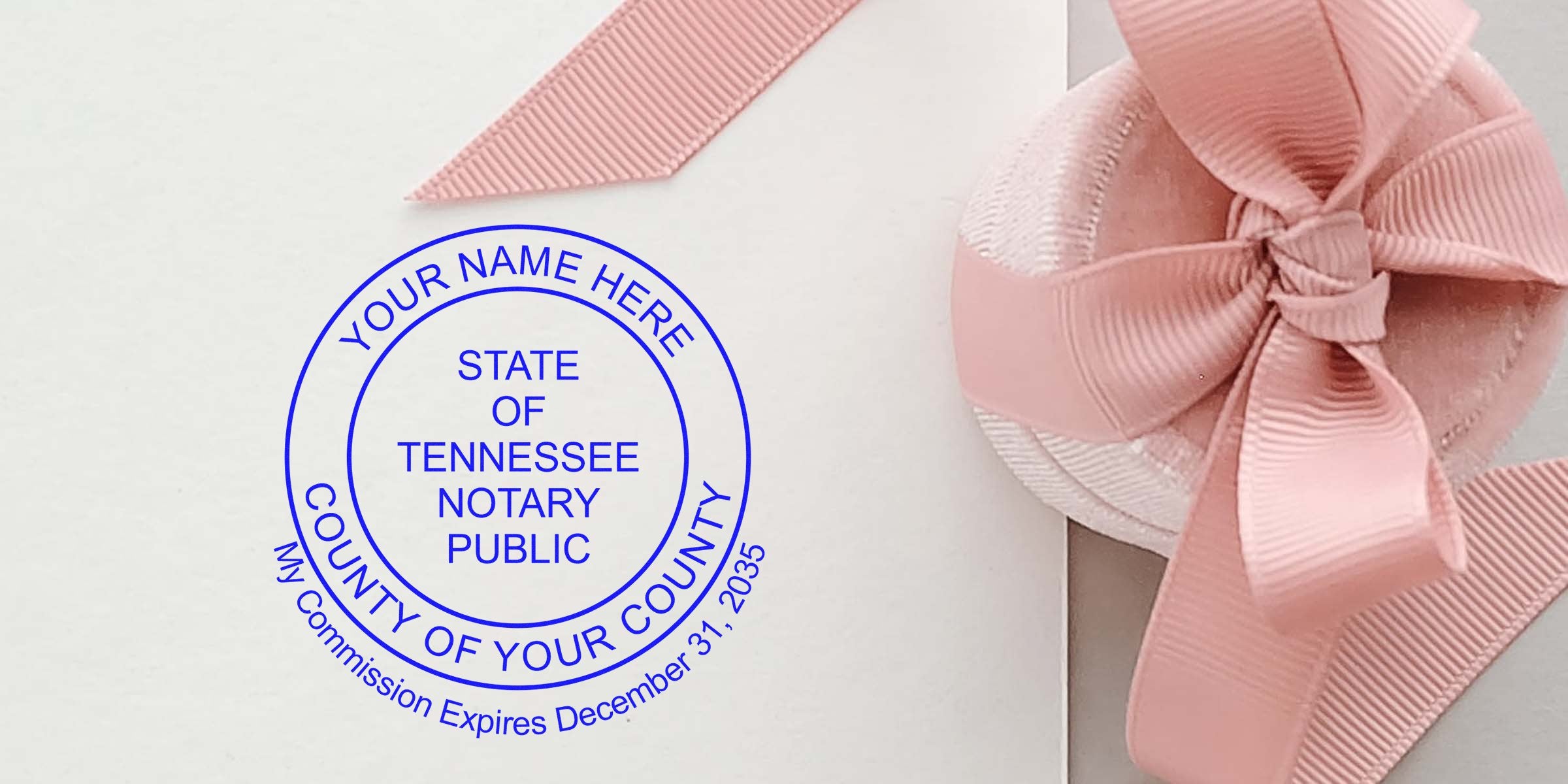 Blue circular Tennessee notary public stamp impression on white paper beside a pastel gift box with a pink ribbon bow; customizable name, county and commission expiration text visible.