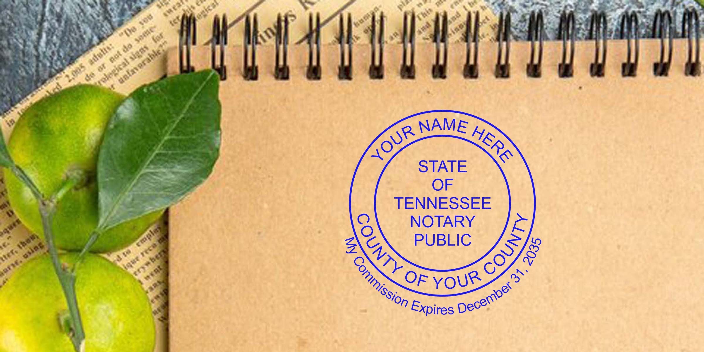 Spiral kraft paper notebook with green limes and leaves, featuring a blue round "State of Tennessee Notary Public" stamp mockup with customizable name and county.
