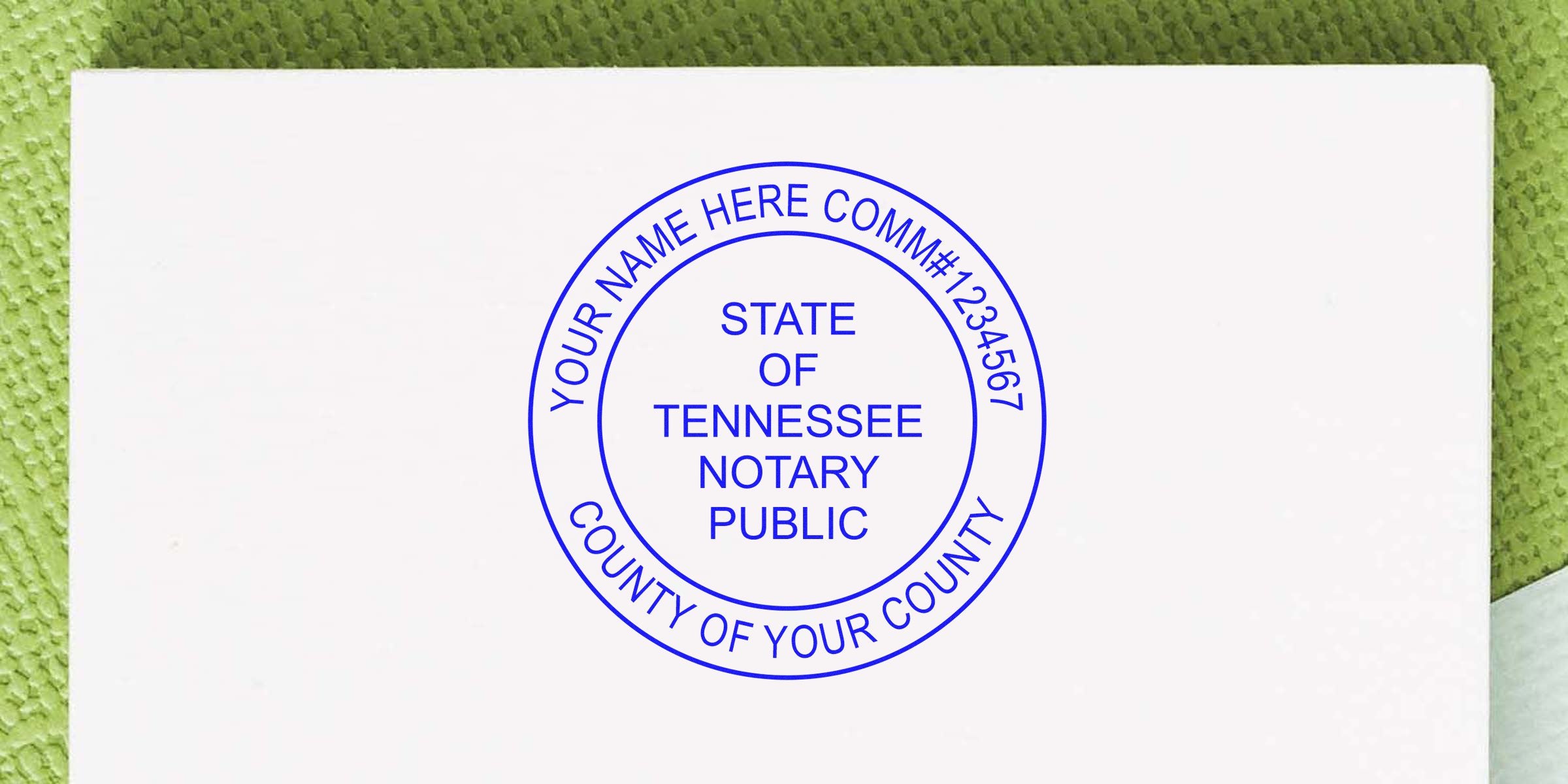 Blue circular Tennessee notary public stamp on white paper reading "STATE OF TENNESSEE NOTARY PUBLIC" with outer ring for customizable name, commission number and county, textured green background.