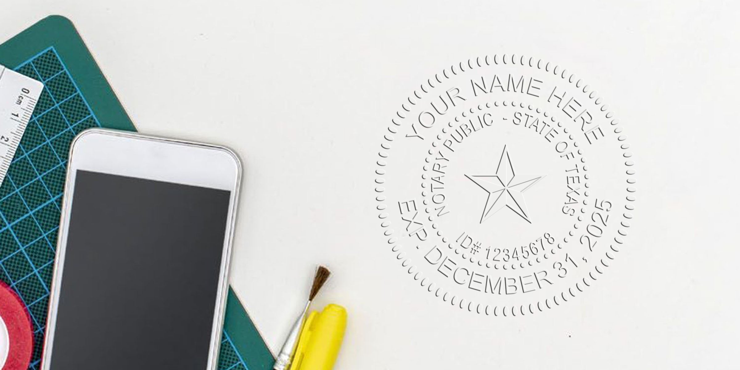 Top-down workspace with smartphone, cutting mat, ruler, paintbrush and highlighter beside a notary embossing seal impression for Texas notary expiring December 31, 2025