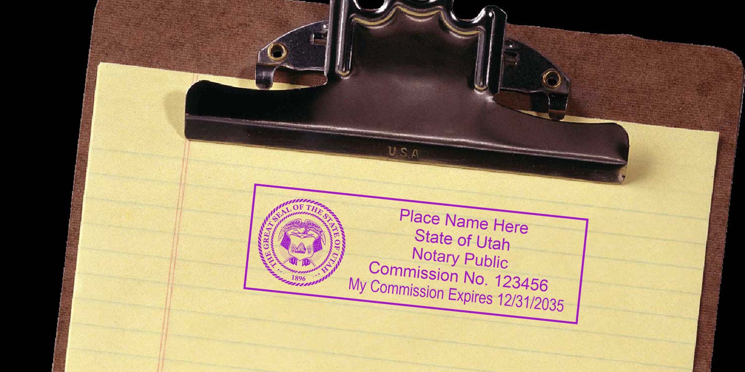 Brown clipboard with yellow legal pad showing a purple Utah notary public stamp sample including state seal, sample name, commission number and expiration date, office supplies, legal document accessory, notary stamp mockup