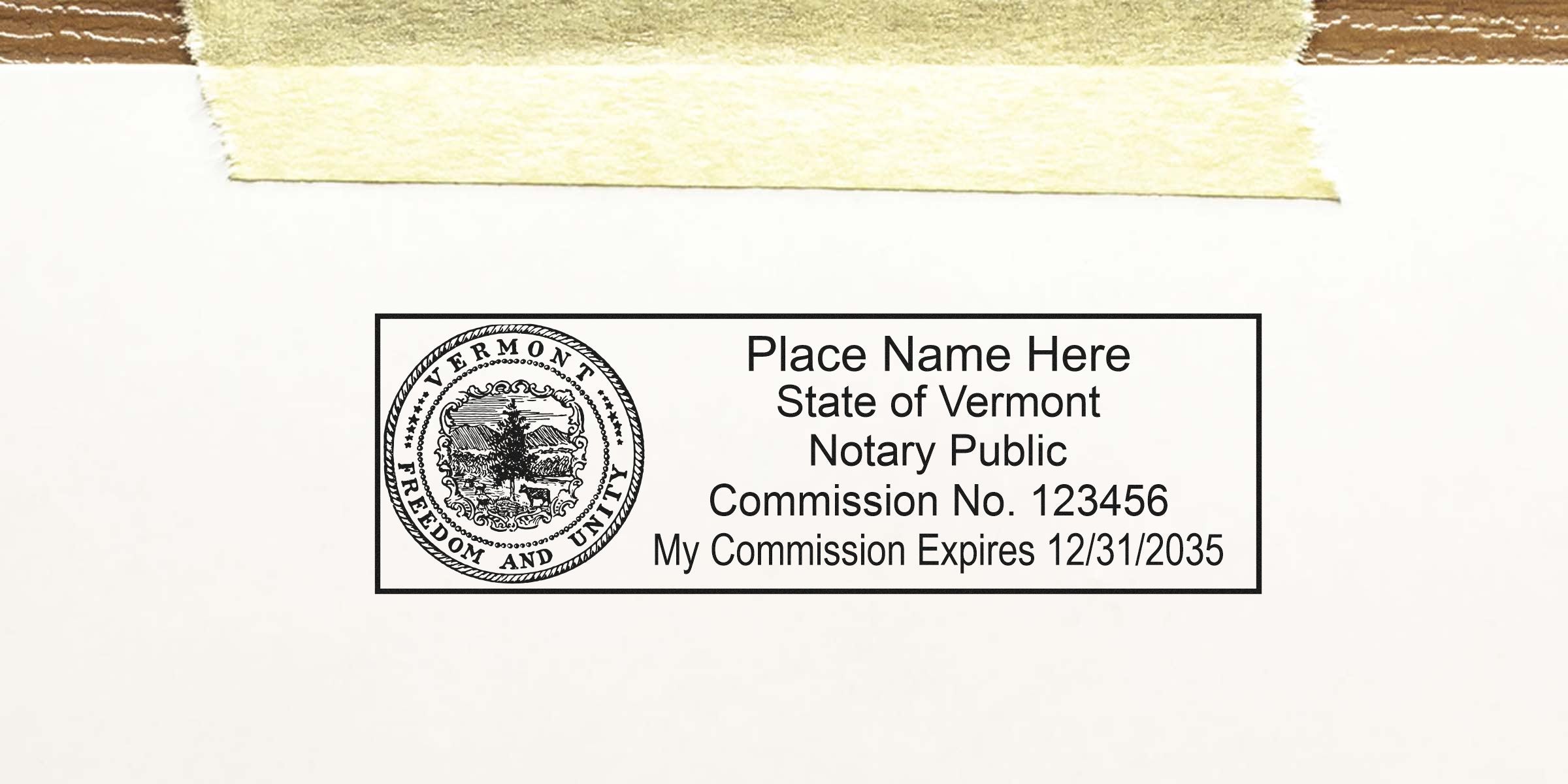 Vermont notary public stamp sample with state seal, placeholder name, commission number and expiration date printed inside a rectangular border, taped to white paper background