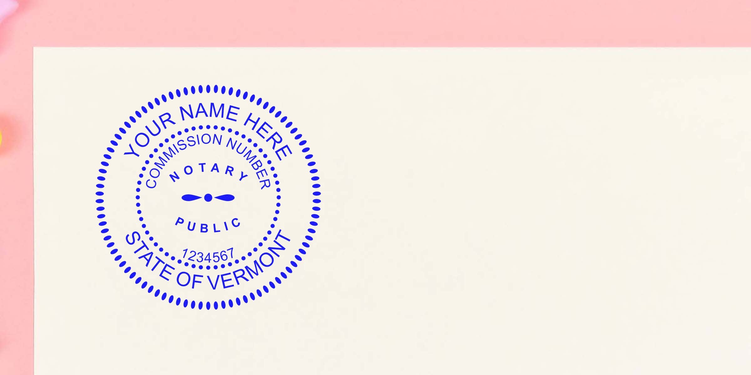 Blue circular notary seal reading "Notary Public," "State of Vermont," sample commission number and "Your Name Here" stamped on cream paper with a pink border.