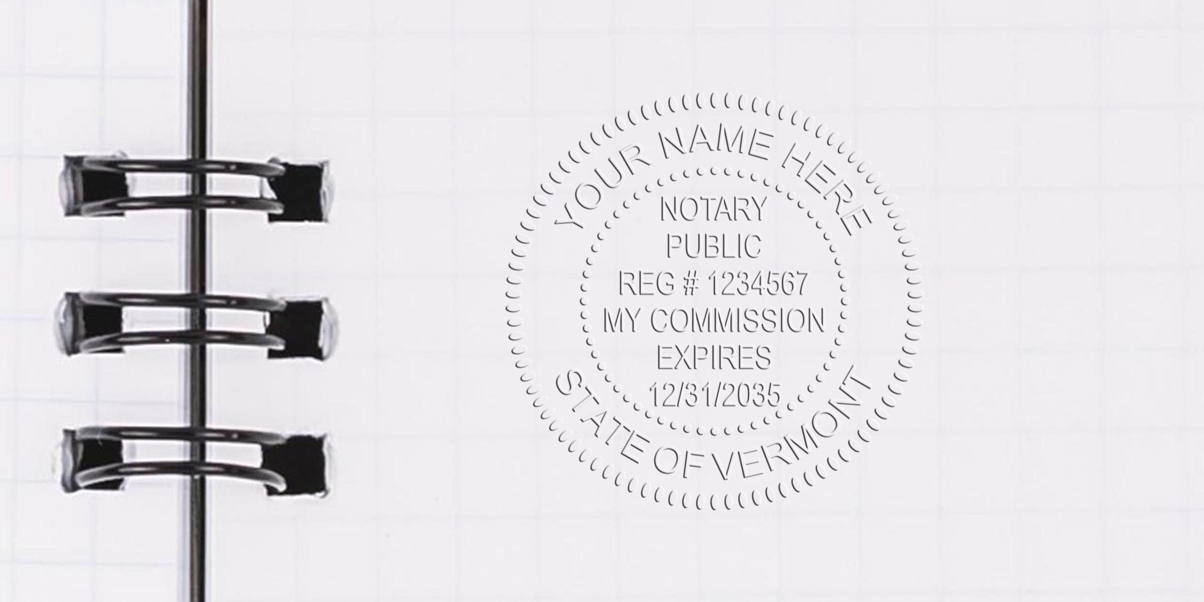 Embossed notary public seal reading "State of Vermont" on white graph paper beside black spiral notebook rings, close-up of paper embossing and binder hardware for legal document or stationery concept