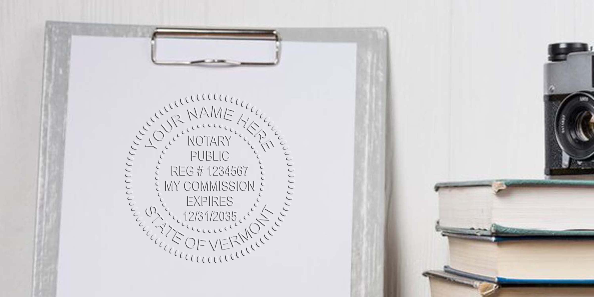 Clipboard with paper embossed with a notary public seal (State of Vermont) next to a stack of books and a vintage camera on a desk
