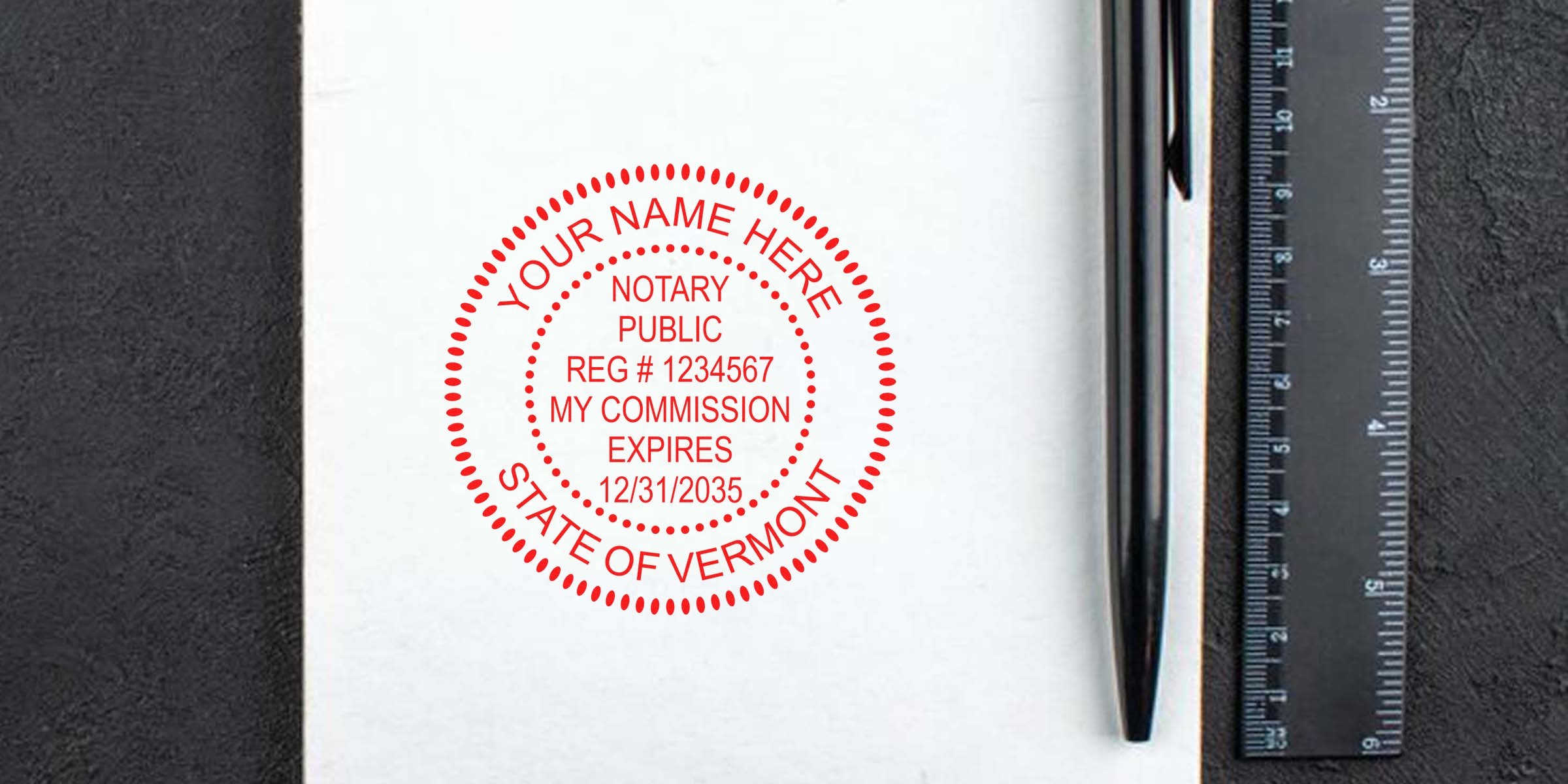 Red circular notary public stamp mockup reading "Your Name Here, State of Vermont" printed on white paper next to a black pen and ruler.