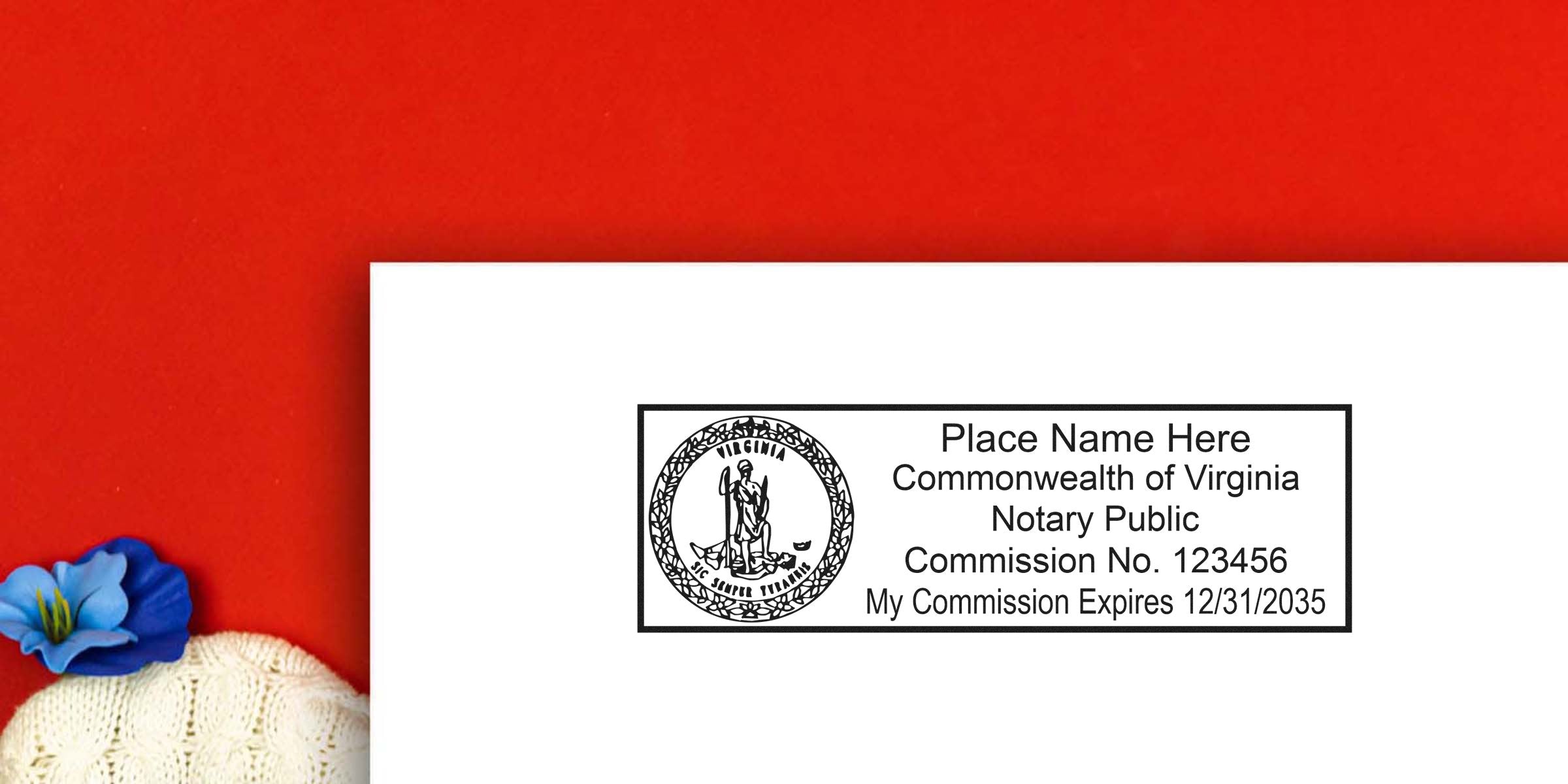 Virginia notary public stamp sample on white paper showing state seal, placeholder name, commission number and expiration date, placed on red background with a blue flower and cream knit fabric.