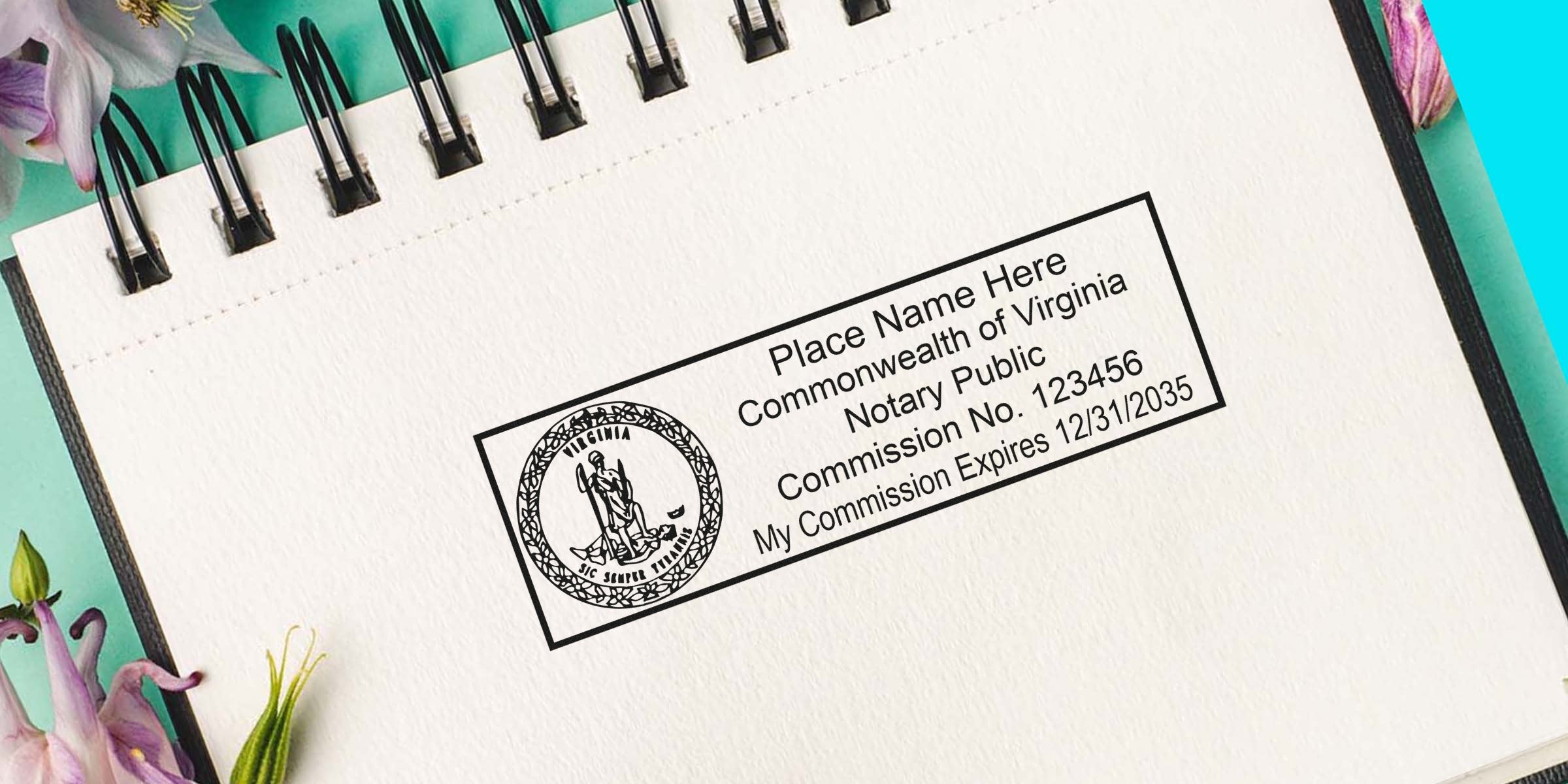 Close-up of a Commonwealth of Virginia notary public rectangular stamp with state seal and sample commission details on a spiral notebook page with floral accents.