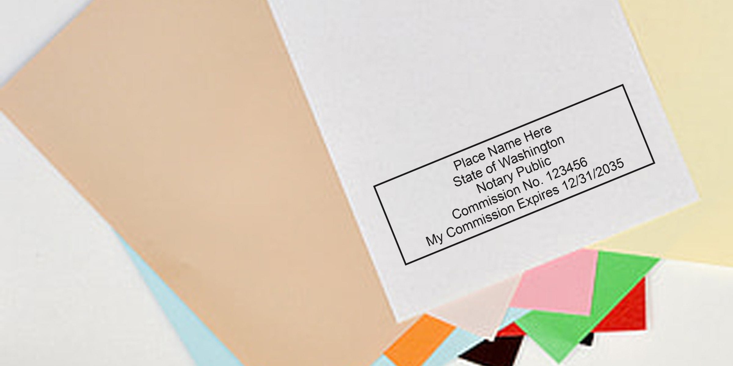 Close-up of a rectangular notary public stamp sample on stacked colorful paper sheets showing placeholder name, state, commission number and expiration date for document authentication
