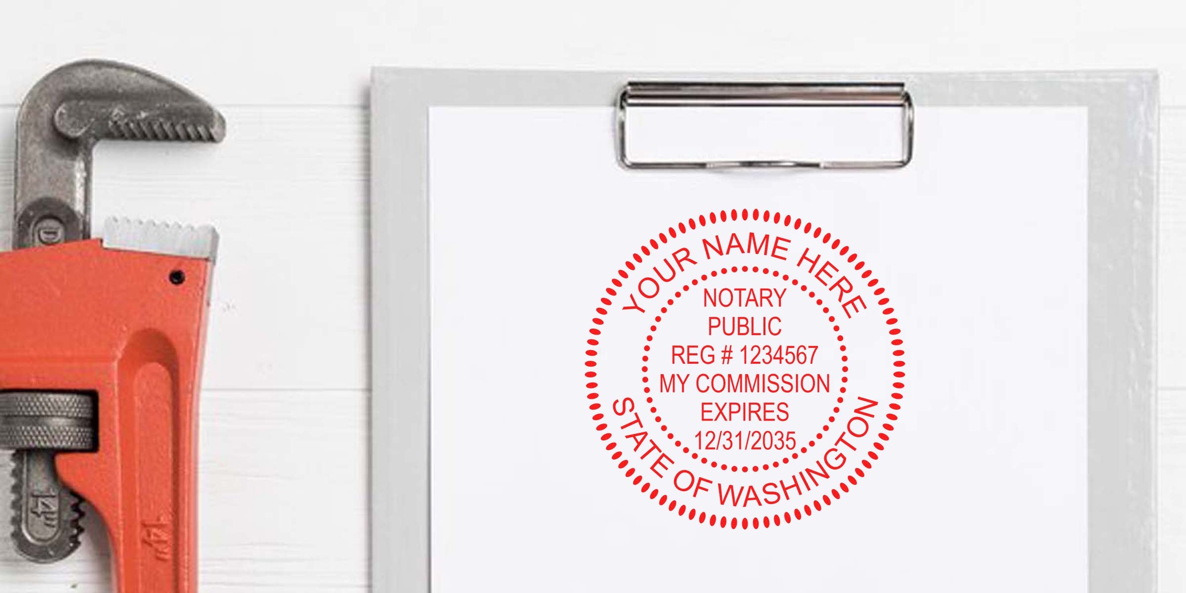 Clipboard with white paper stamped in red "Notary Public - State of Washington" seal and expiration date, beside an orange pipe wrench on white wood background — notary stamp, clipboard, plumbing tool, office document image.