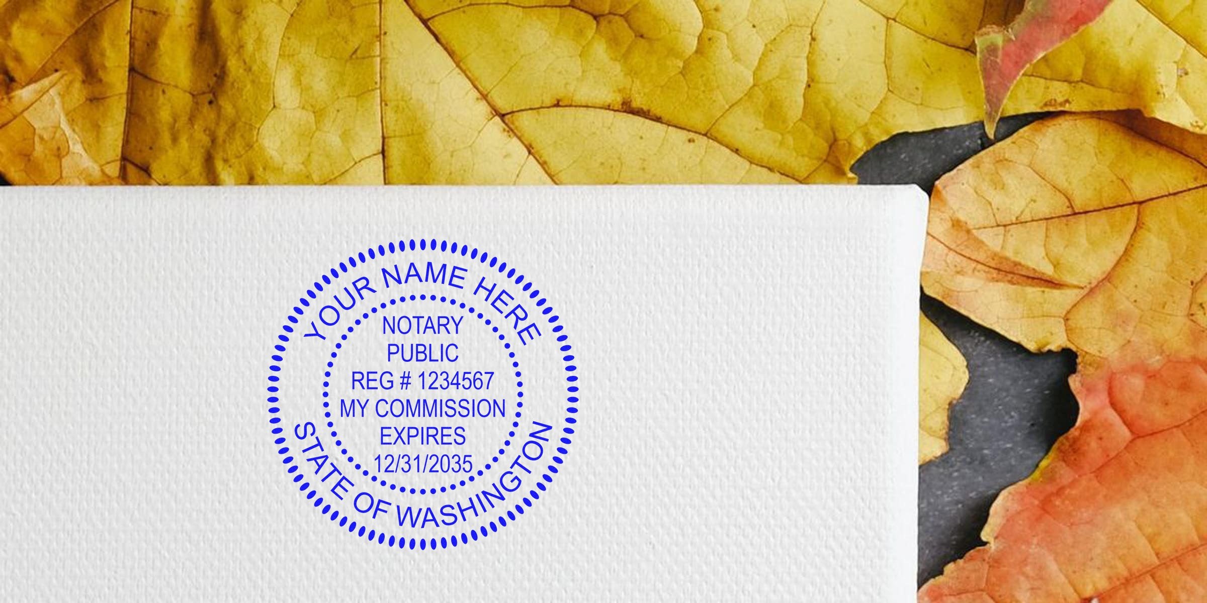 Blue circular "State of Washington" notary public stamp mockup on textured white paper reading "Your Name Here" and commission details, with yellow and orange autumn leaves in background.