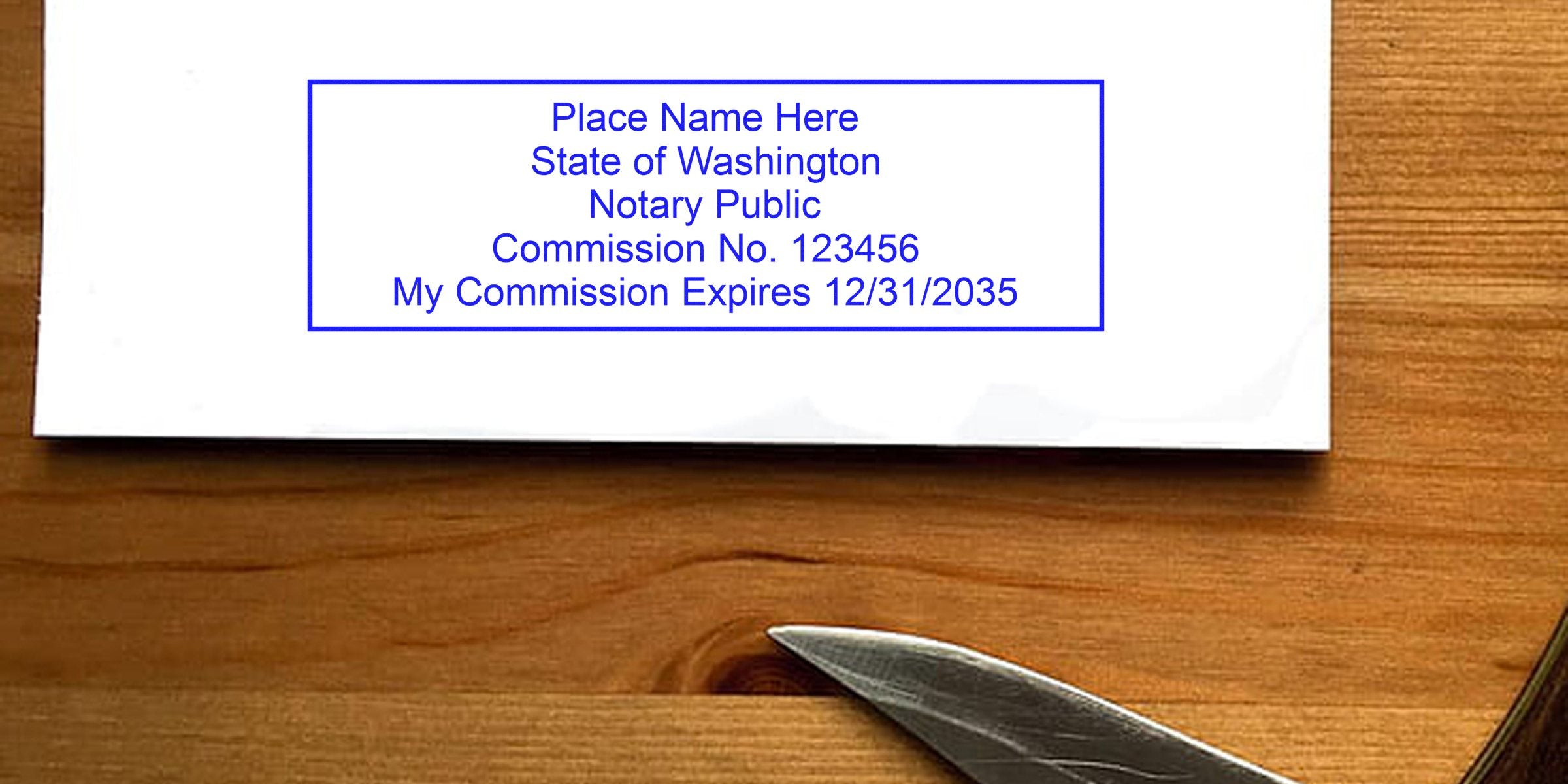 White envelope on a wooden table with a blue rectangular notary stamp reading "Place Name Here, State of Washington, Notary Public, Commission No. 123456, My Commission Expires 12/31/2035," and a metal letter opener at the corner