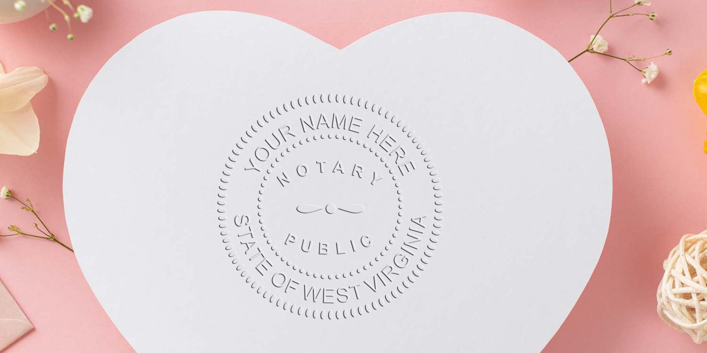 Heart-shaped white card with an embossed notary public seal reading "Your Name Here, Notary Public, State of West Virginia" on a pink background with small flowers and decorative twine
