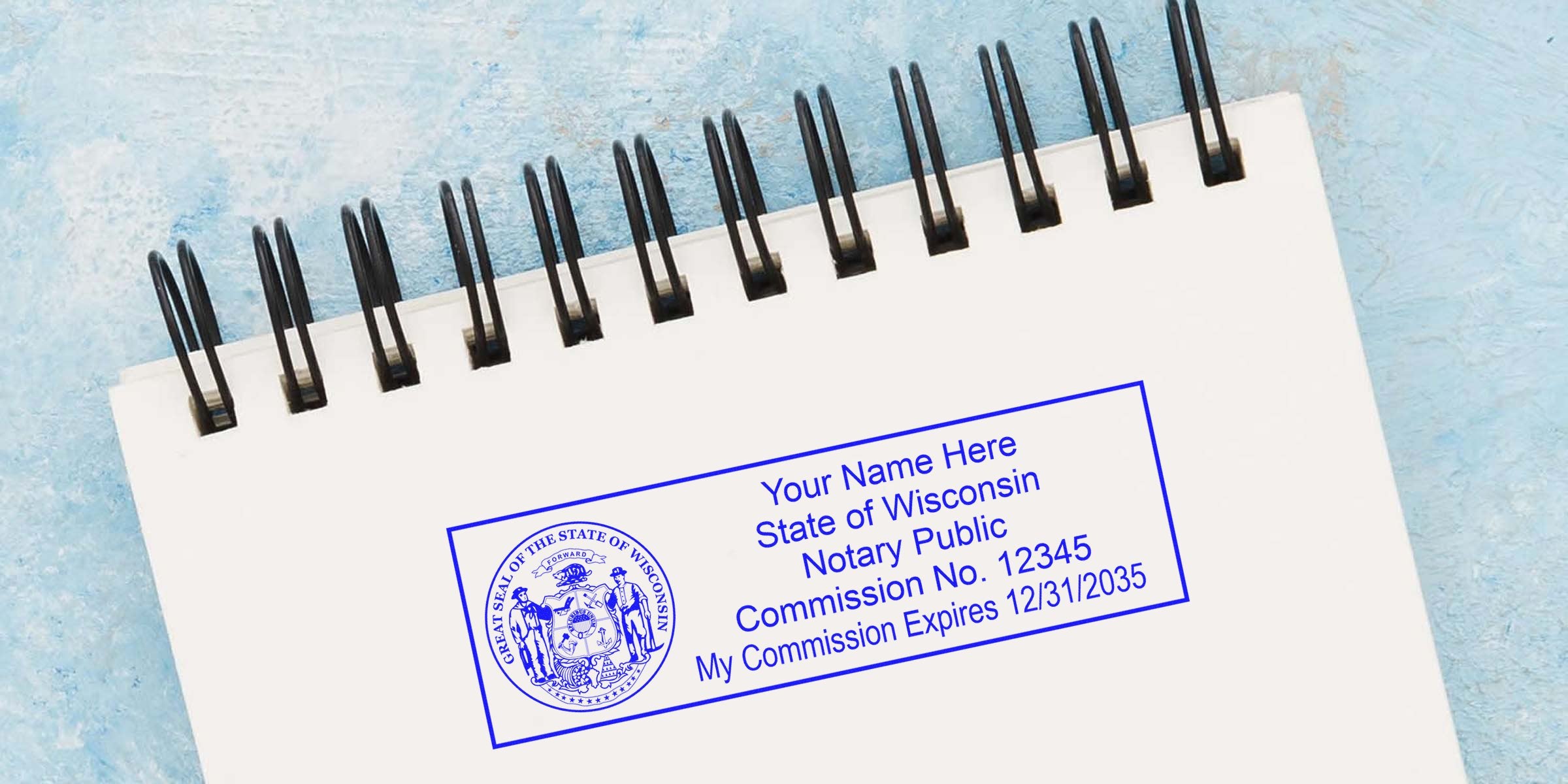 Spiral notebook page with a blue Wisconsin notary public stamp showing state seal, sample name, commission number and expiration date, angled on a textured blue background